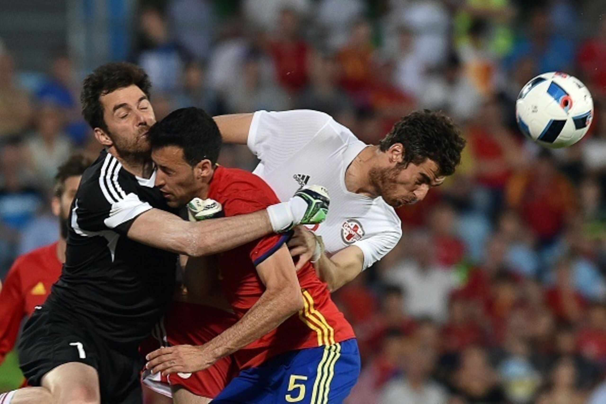 Georgia's goalkeeper Nukri Revishvili (L) collides with Spain's midfielder Sergio Busquets (C) past Georgia's defender Solomon Kverkvelia during the EURO 2016 friendly football match Spain vs Georgia at the Coliseum Alfonso Perez stadium in Getafe, on Jun Georgia's goalkeeper Nukri Revishvili (L) collides with Spain's midfielder Sergio Busquets (C) past Georgia's defender Solomon Kverkvelia during the EURO 2016 friendly football match Spain vs Georgia at the Coliseum Alfonso Perez stadium in Getafe, on Jun
