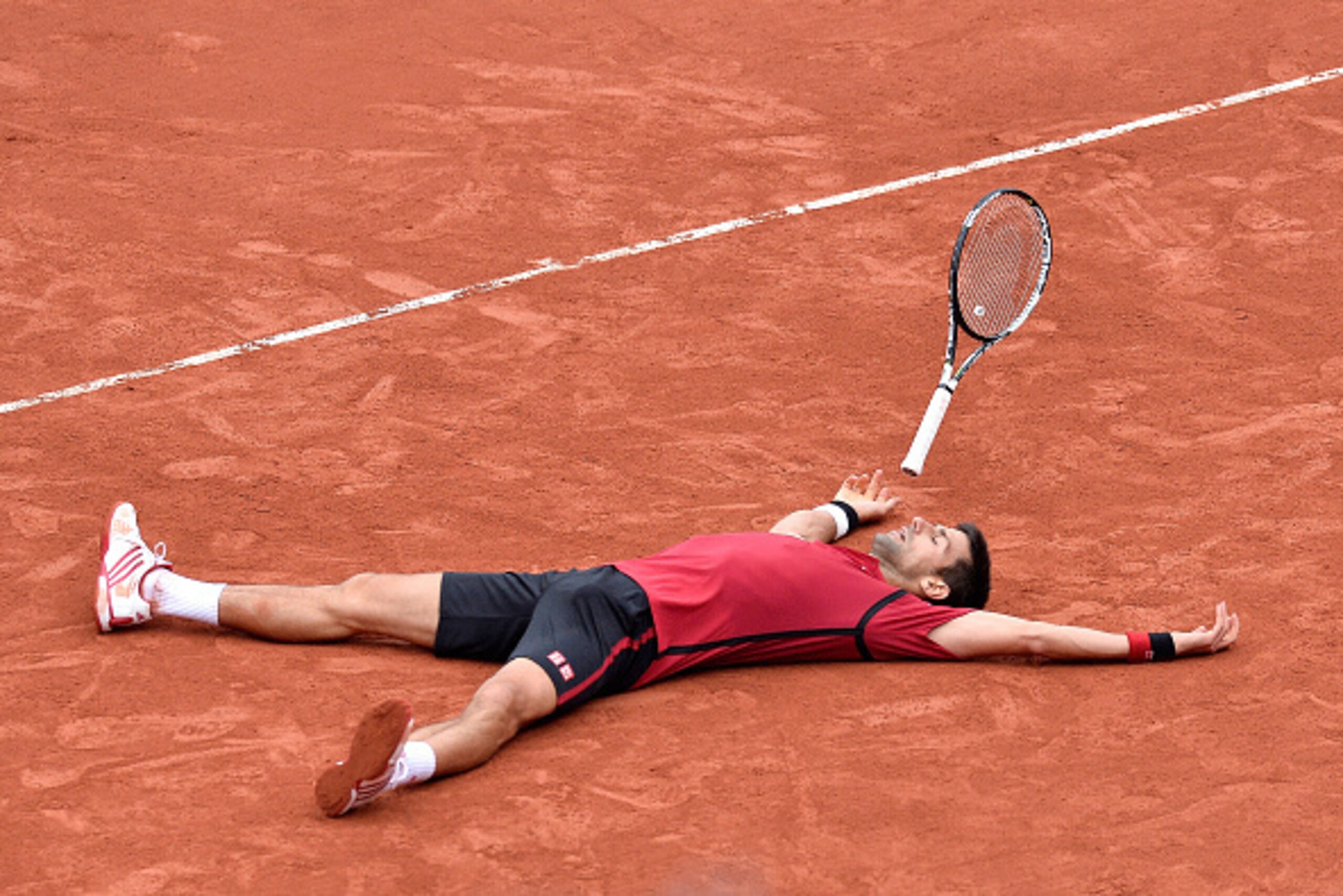 PARIS, FRANCE - JUNE 05:  Novak Djokovic of Serbia reacts after winning his men's singles final match against Andy Murray of Great Britain on day fifteen of the 2016 French Open at Roland Garros on June 5, 2016 in Paris, France.  (Photo by Aurelien Meunie