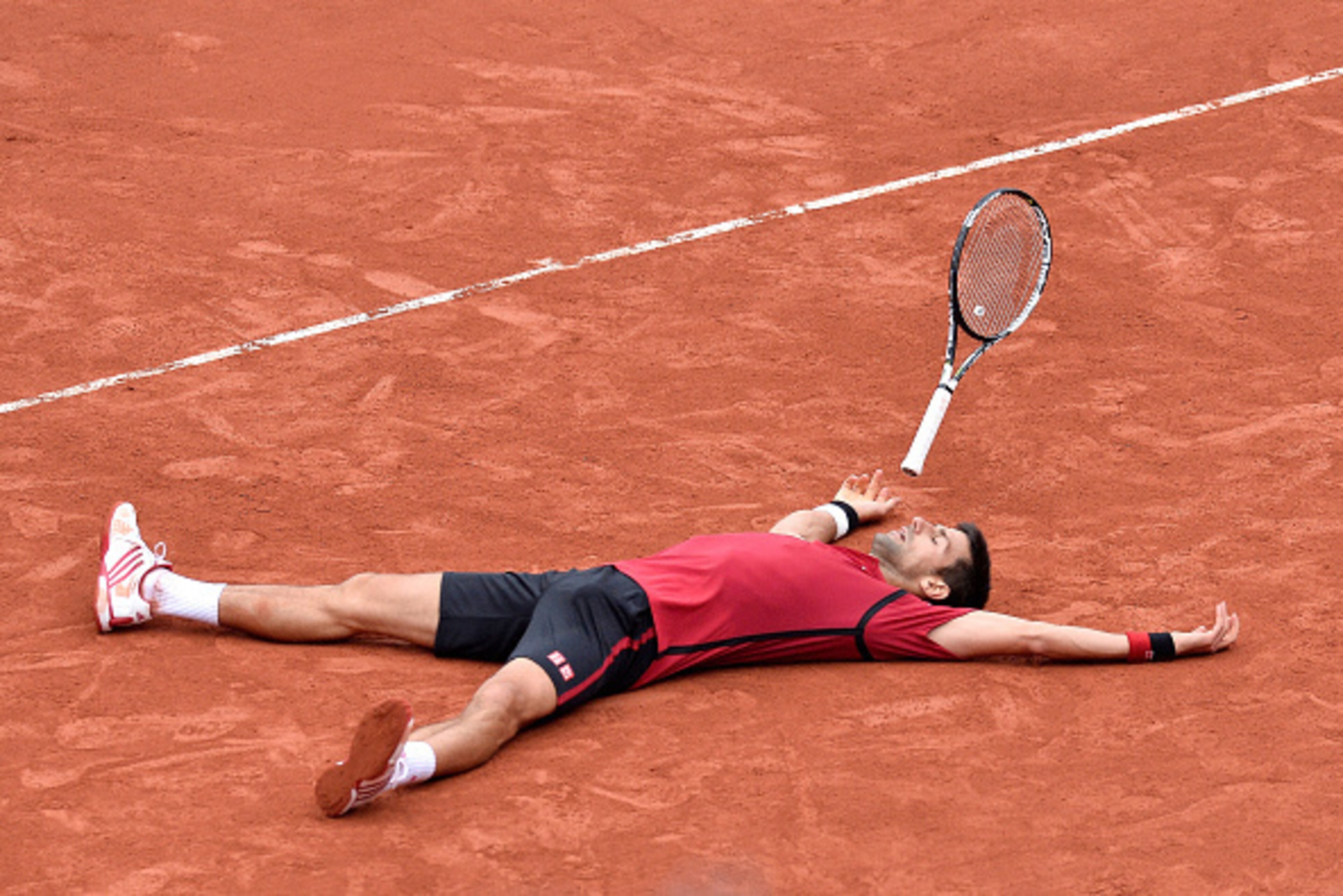 PARIS, FRANCE - JUNE 05:  Novak Djokovic of Serbia reacts after winning his men's singles final match against Andy Murray of Great Britain on day fifteen of the 2016 French Open at Roland Garros on June 5, 2016 in Paris, France.  (Photo by Aurelien Meunie