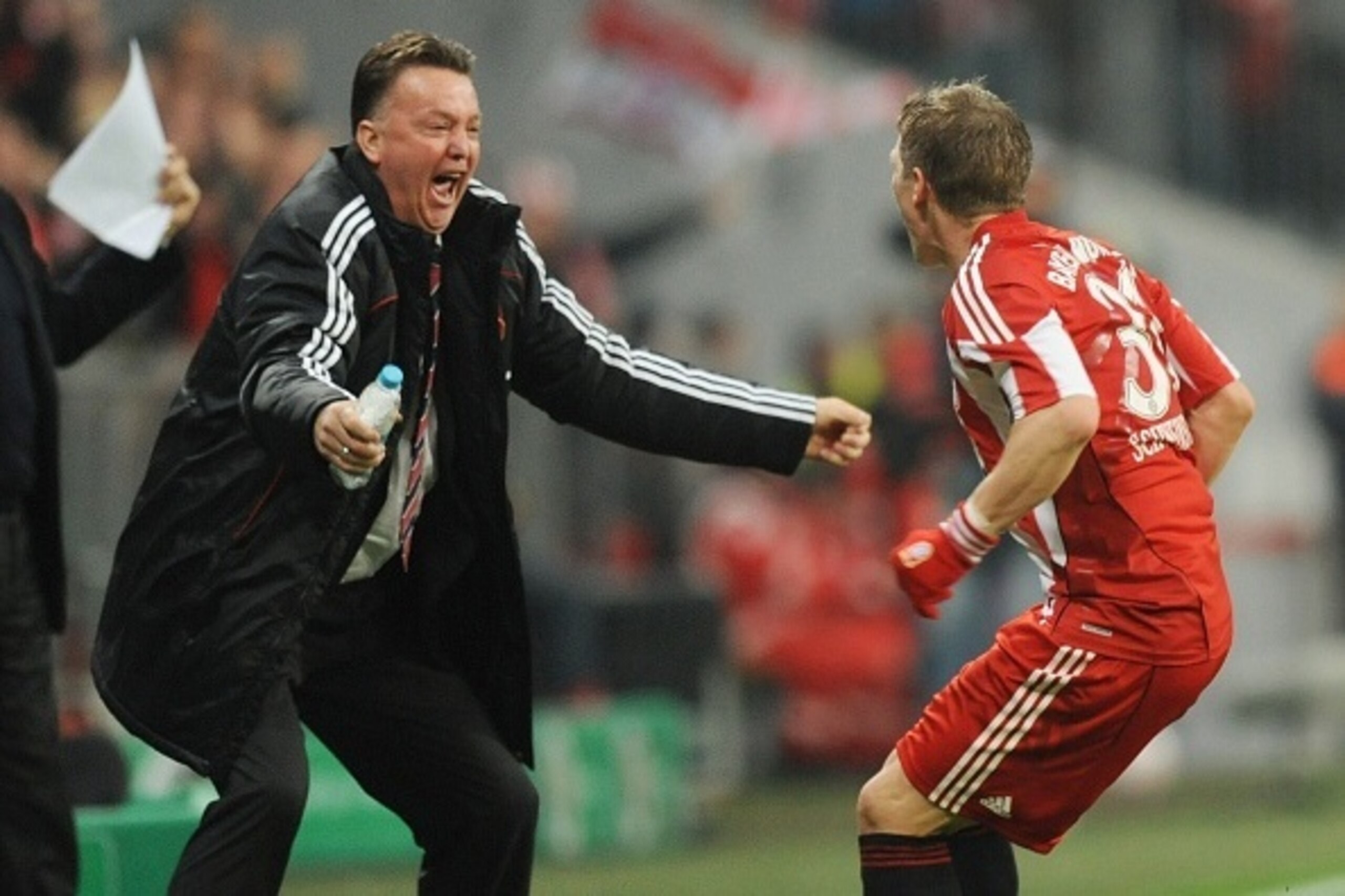 (FILES) - Picture taken on October 26, 2010 shows Bayern Munich's midfielder Bastian Schweinsteiger (R) celebrating scoring with Bayern Munich's Dutch head coach Louis van Gaal during the DFB German Cup football match FC Bayern Munich vs Werder Bremen in 