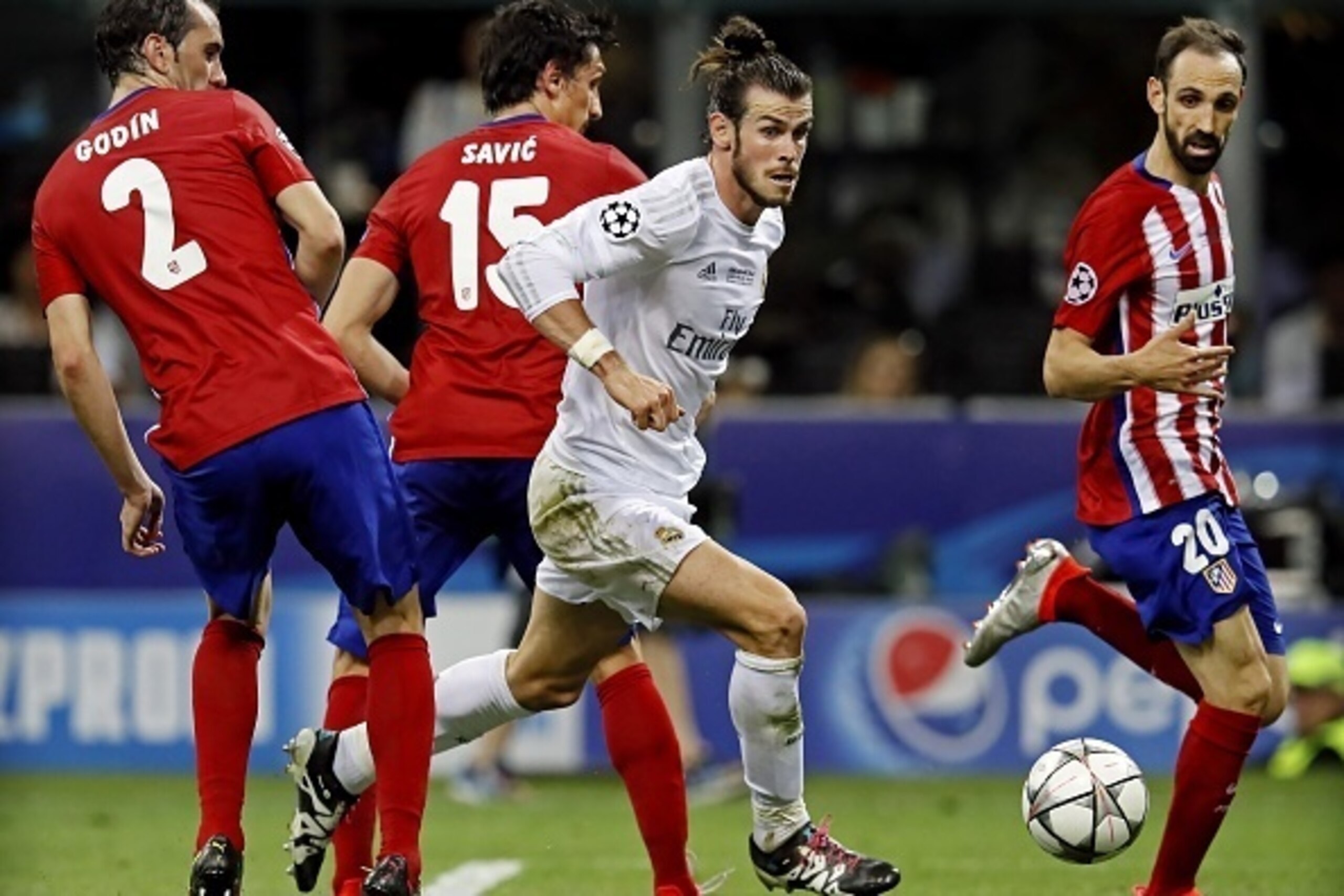 (L-R) Diego Godin, Stefan Savic of Atletico Madrid, Gareth Bale of Real Madrid, Juanfran of Atletico Madrid during the UEFA Champions League final match between Real Madrid and Atletico Madrid on May 28, 2016 at the Giuseppe Meazza San Siro stadium in Mil