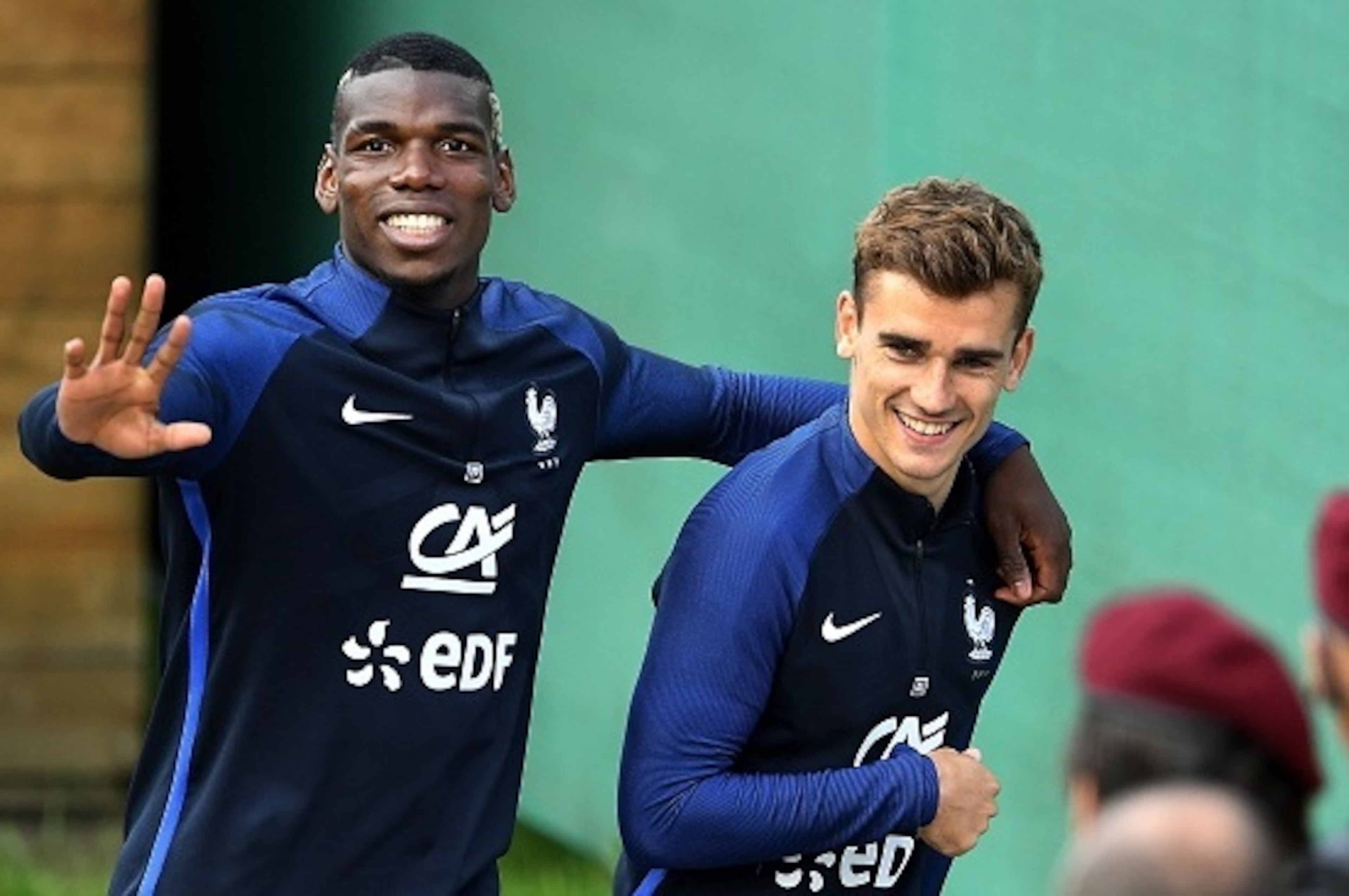 France's midfielder Paul Pogba (L) and France's forward Antoine Griezmann react at the end of a training session in Neustift im Stubaital, on June 1, 2016, as part of the team's preparation for the upcoming Euro 2016 European football championships.  / AF