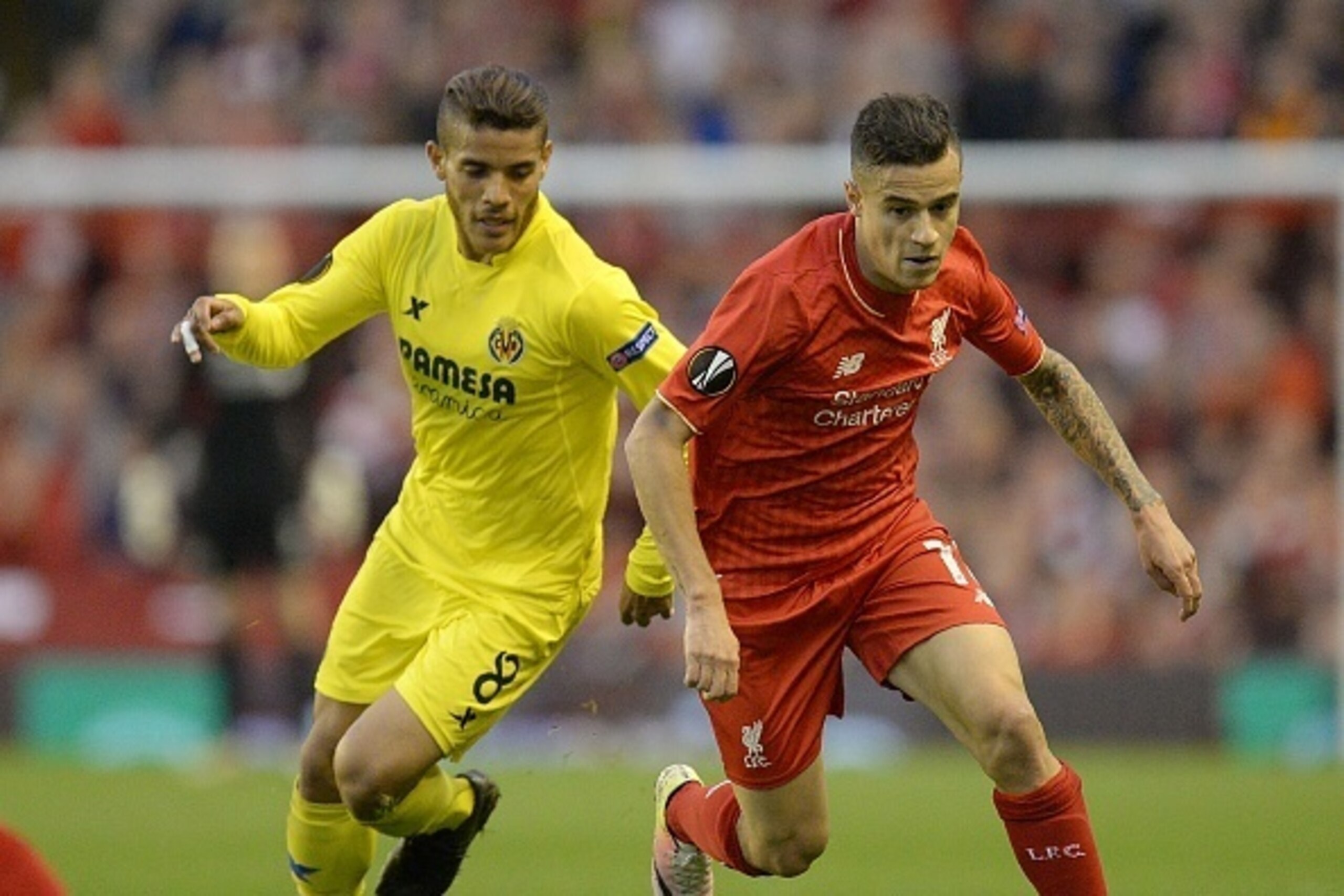 Liverpool's Brazilian midfielder Philippe Coutinho (R) vies for the ball against Villarreal's Mexican forward Jonathan dos Santos during the UEFA Europa League semi-final second leg football match between Liverpool and Villarreal CF at Anfield in Liverpoo