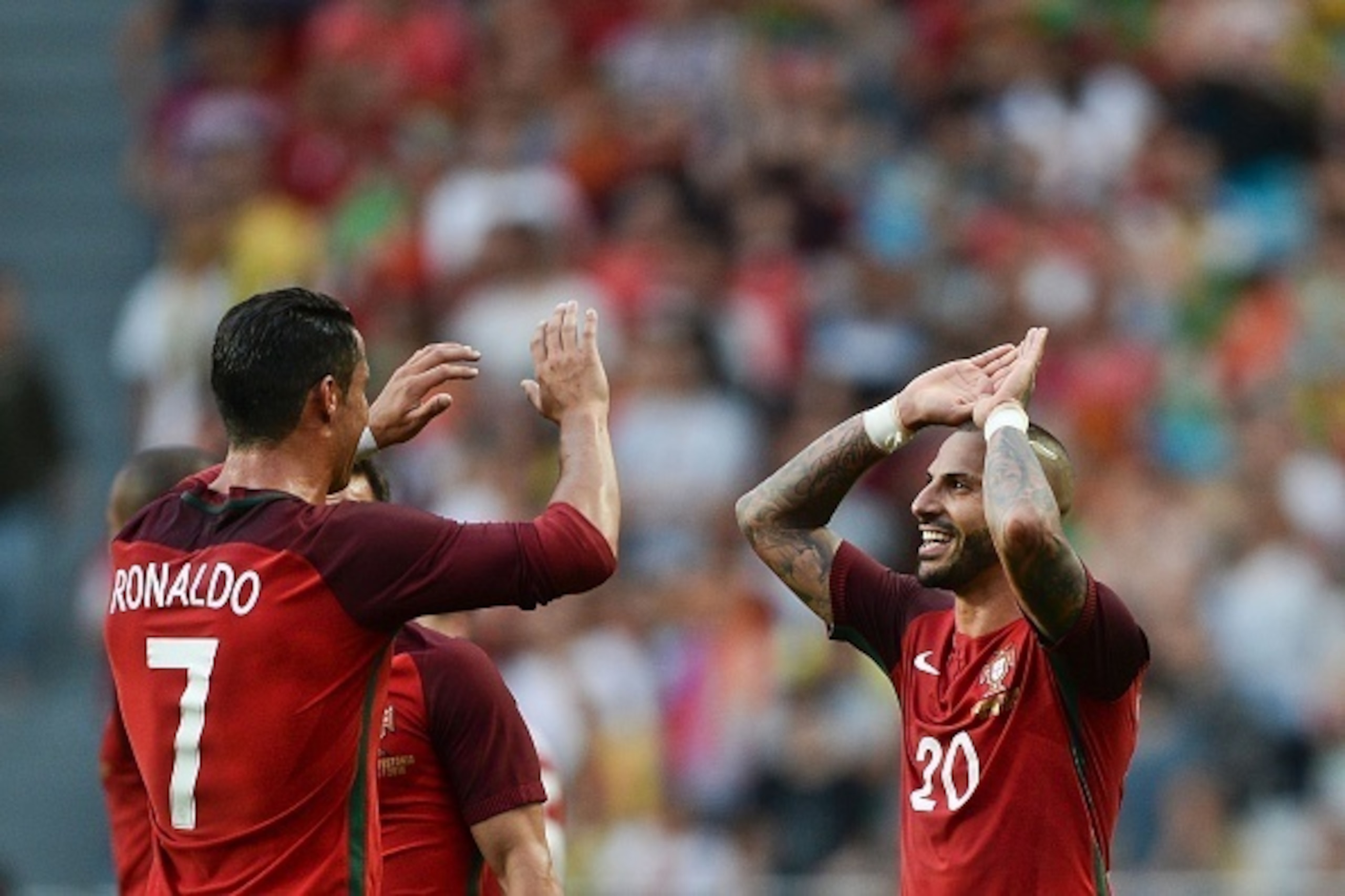 Portugal's forward Ricardo Quaresma (R) celebrates with his teammate Portugal's forward Cristiano Ronaldo (L) after scoring against Estonia during the friendly football match Portugal vs Estonia at Luz stadium in Lisbon on June 8, 2016, in preparation for