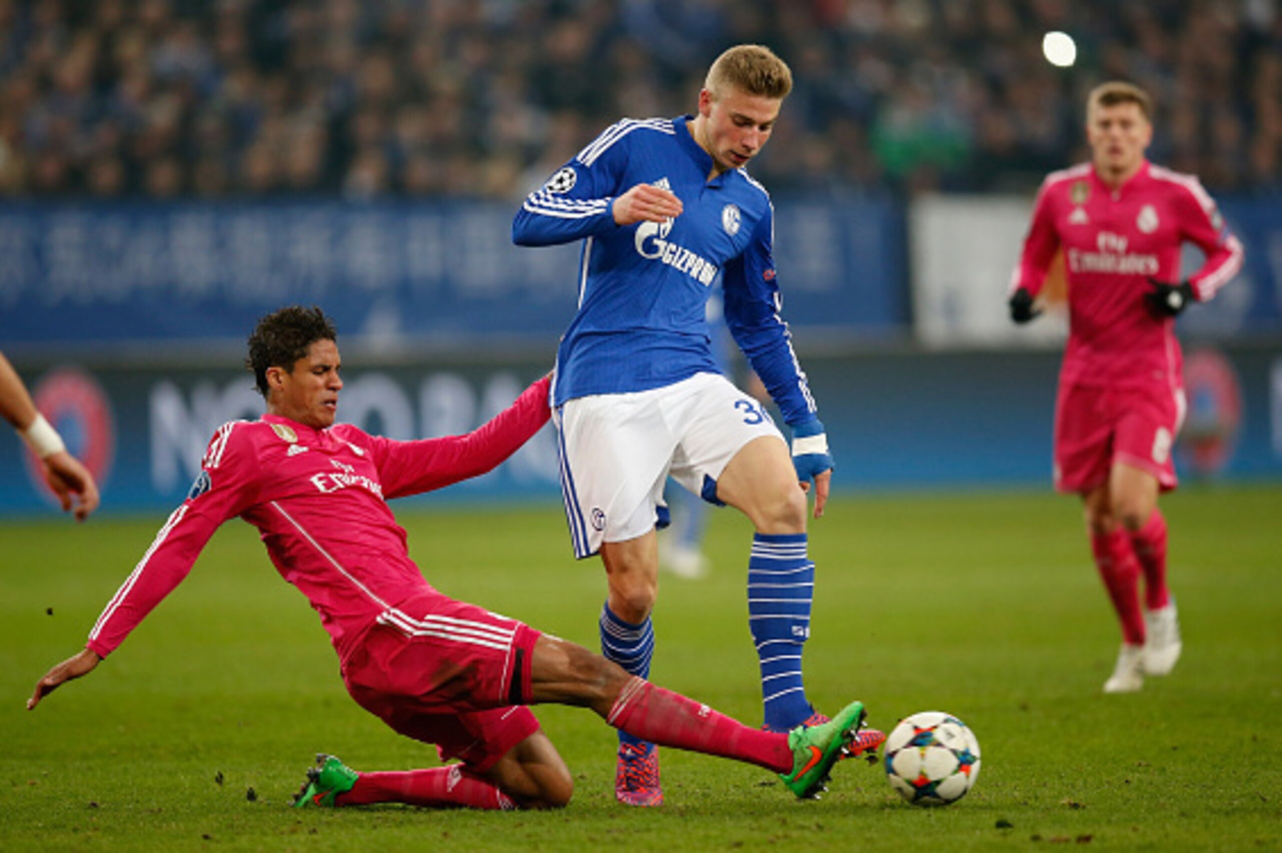 GELSENKIRCHEN, GERMANY - FEBRUARY 18:  Raphael Varane (L) of Real Madrid tackles Felix Platte of Schalke during the UEFA Champions League Round of 16 match between FC Schalke 04 and Real Madrid at the Veltins-Arena on February 18, 2015 in Gelsenkirchen, G