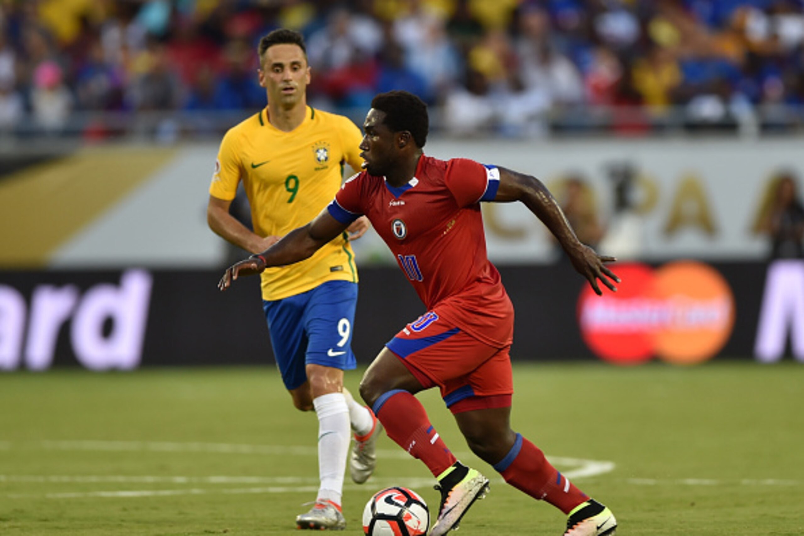 Haiti's Jeff Louis (R) vies for the ball with Brazil's Jonas during a Copa America Centenario football match in Orlando, Florida, United States, on June 8, 2016. / AFP / Hector RETAMAL (Photo credit should read HECTOR RETAMAL/AFP/Getty Images) Haiti's Jeff Louis (R) vies for the ball with Brazil's Jonas during a Copa America Centenario football match in Orlando, Florida, United States, on June 8, 2016. / AFP / Hector RETAMAL (Photo credit should read HECTOR RETAMAL/AFP/Getty Images)