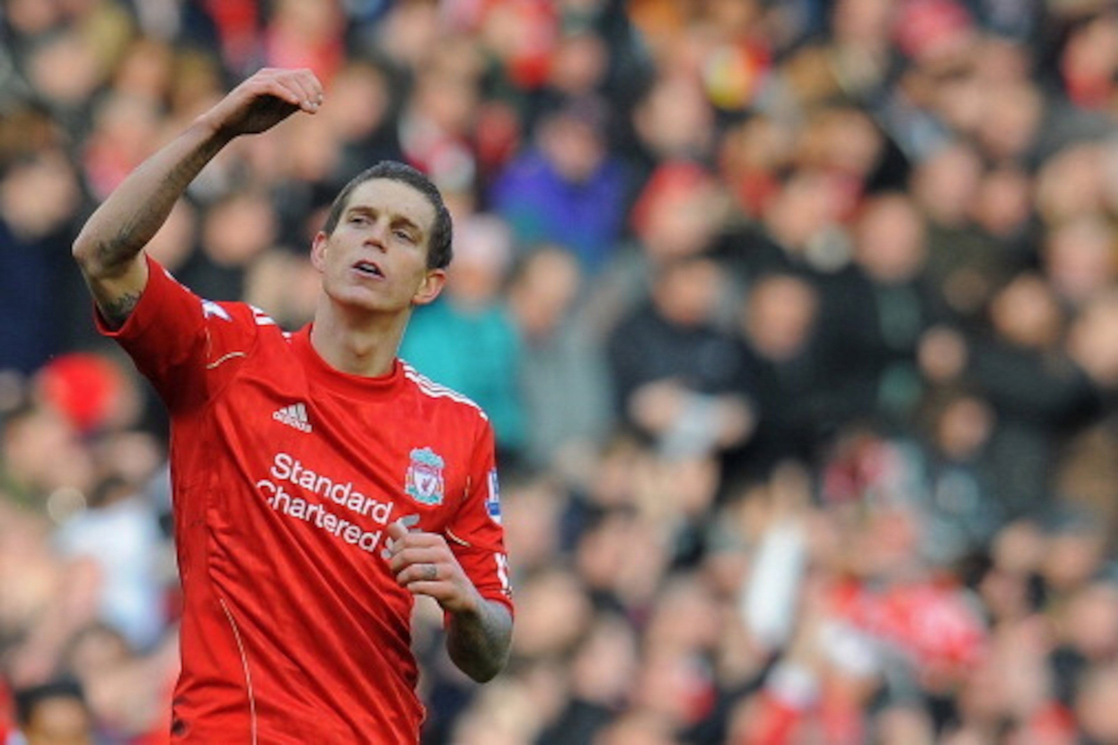 Liverpool's Danish defender Daniel Agger celebrates scoring the opening goal of the English FA Cup fourth round football match between Liverpool and Manchester United at Anfield in Liverpool, north-west England on January 28, 2012. AFP PHOTO/ANDREW YATES
