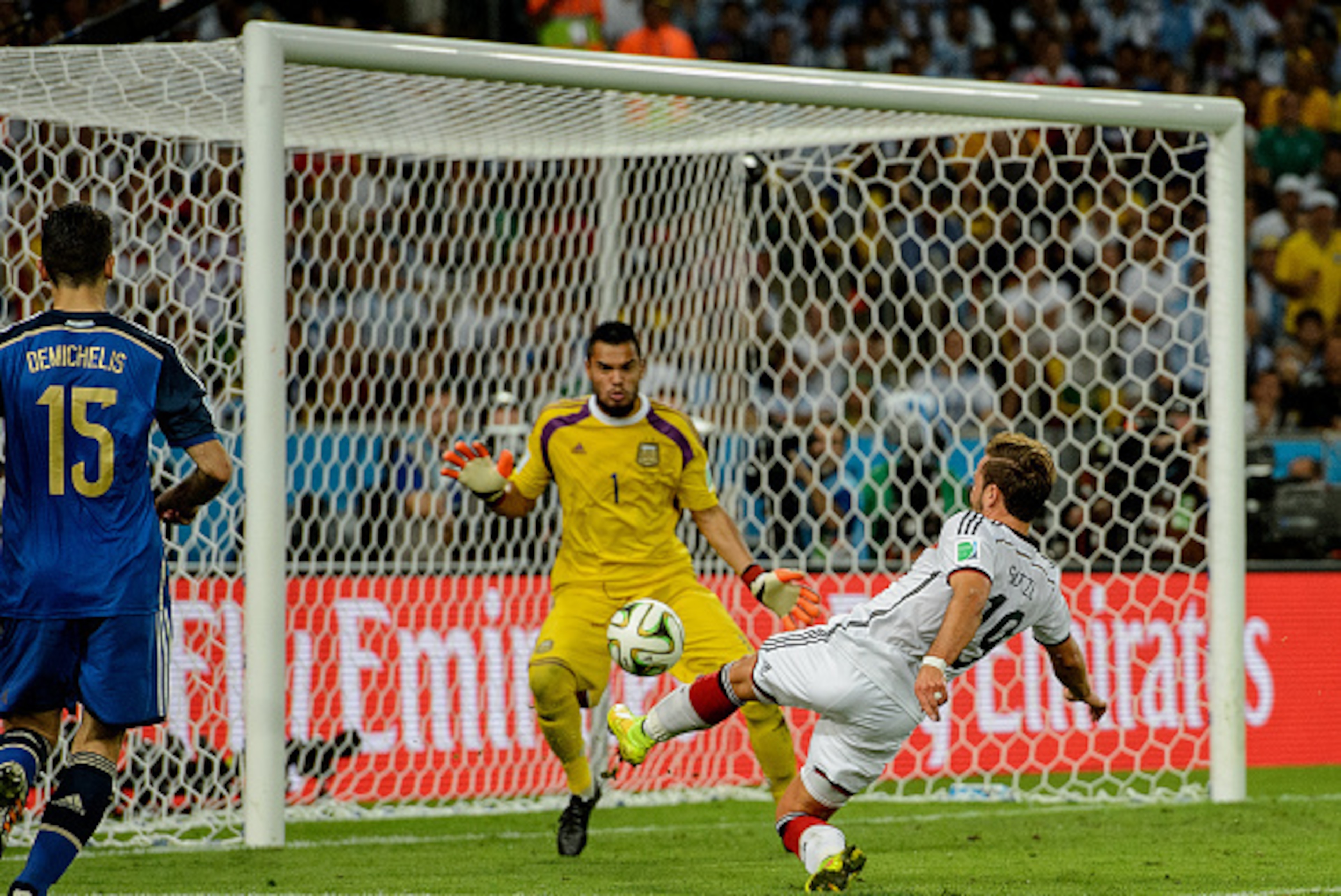 RIO DE JANEIRO, BRAZIL - JULY 13:  Mario Goetze of Germany scores his team's first goal past Sergio Romero of Argentina in extra time during the 2014 FIFA World Cup Brazil Final match between Germany and Argentina at Maracana on July 13, 2014 in Rio de Ja