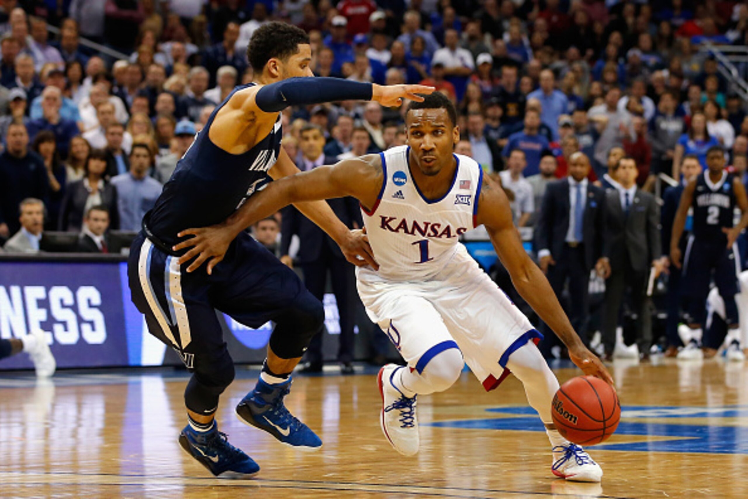 LOUISVILLE, KY - MARCH 26:  Wayne Selden Jr. #1 of the Kansas Jayhawks drives against Josh Hart #3 of the Villanova Wildcats in the second half during the 2016 NCAA Men's Basketball Tournament South Regional at KFC YUM! Center on March 26, 2016 in Louisvi