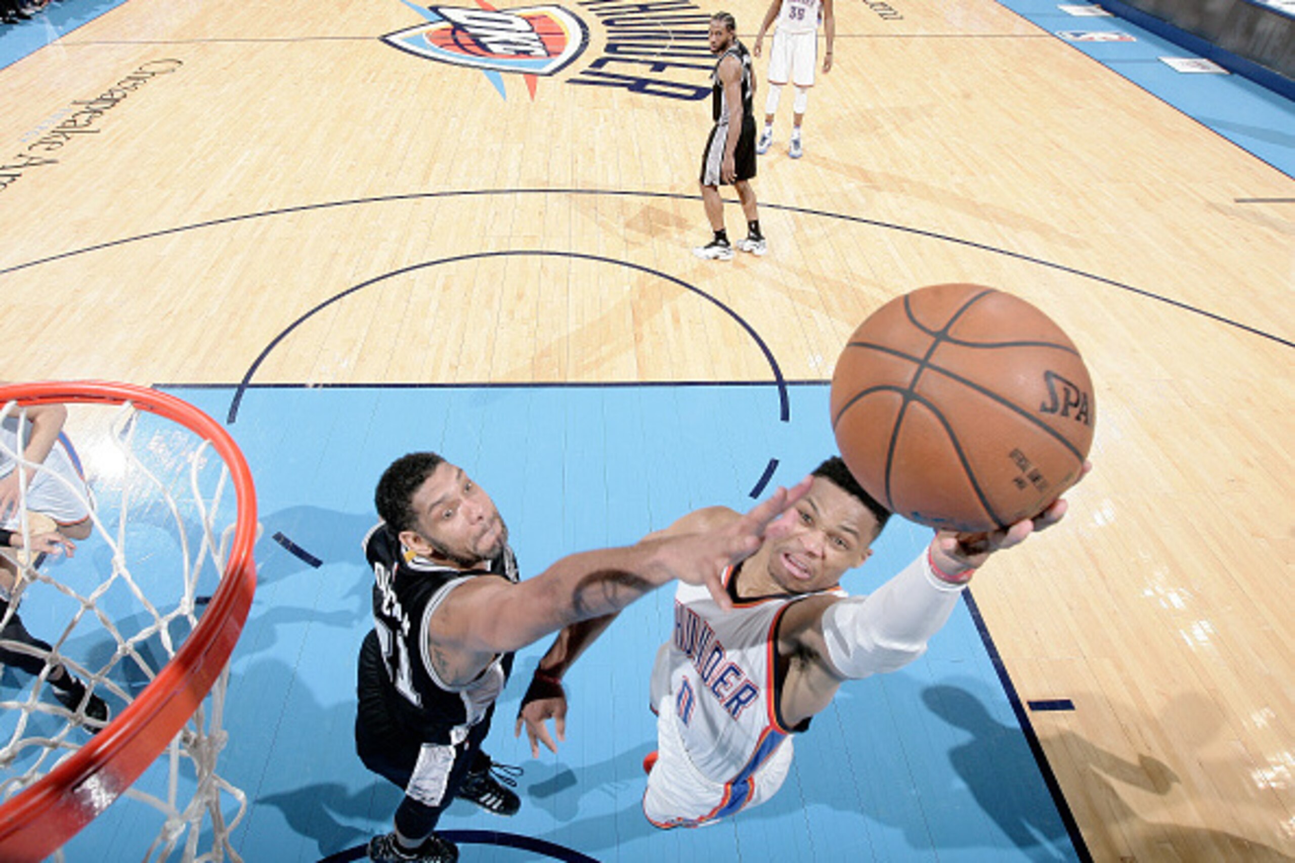 OKLAHOMA CITY, OK- MAY 12:  Russell Westbrook #0 of the Oklahoma City Thunder shoots the ball against Tim Duncan #21 of the San Antonio Spurs in Game Six of the Western Conference Semifinals during the 2016 NBA Playoffs on May 12, 2016 at Chesapeake Energ