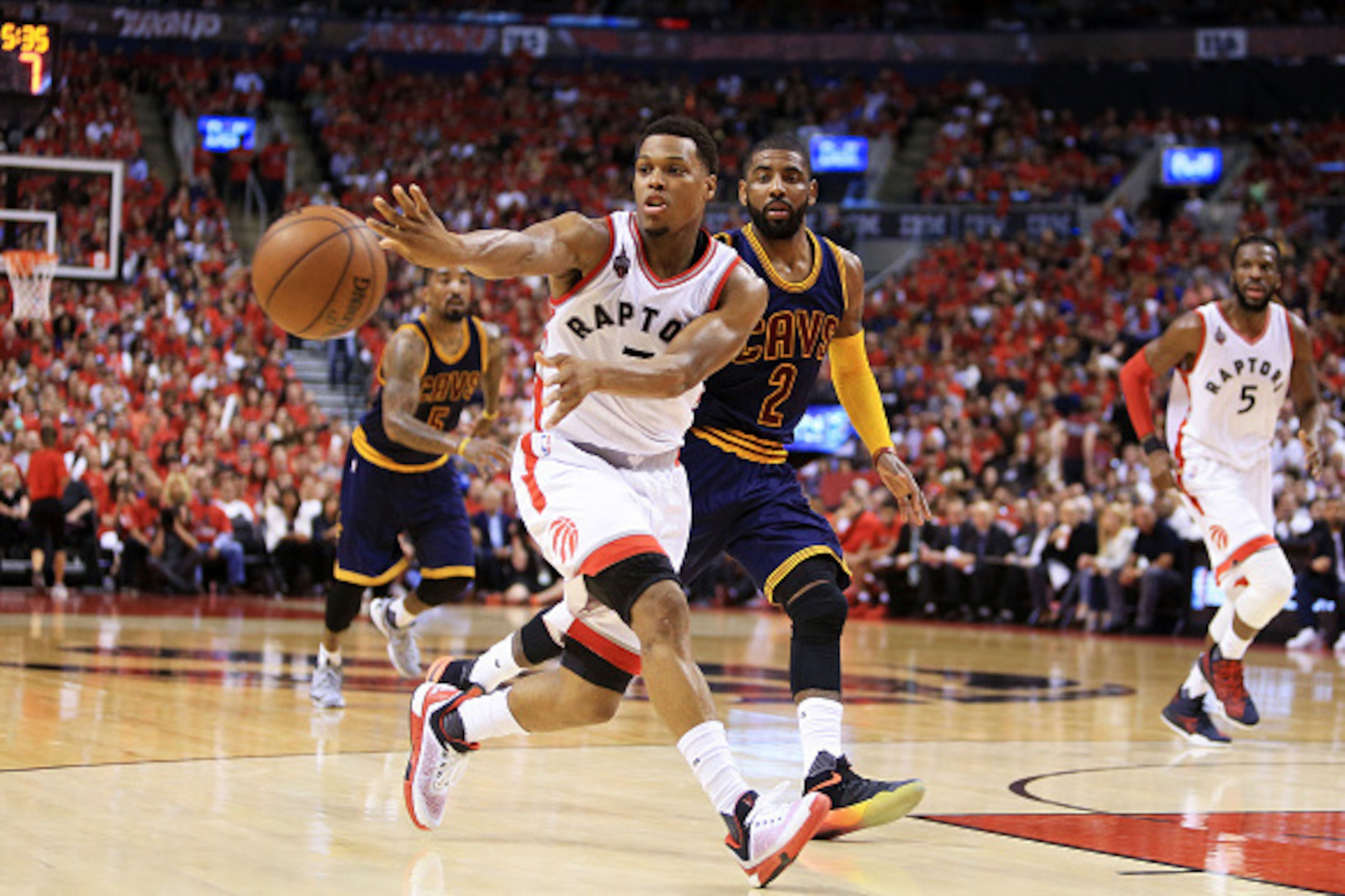 TORONTO, ON - MAY 27:  Kyle Lowry #7 of the Toronto Raptors passes against Kyrie Irving #2 of the Cleveland Cavaliers in the third quarter in game six of the Eastern Conference Finals during the 2016 NBA Playoffs at Air Canada Centre on May 27, 2016 in To