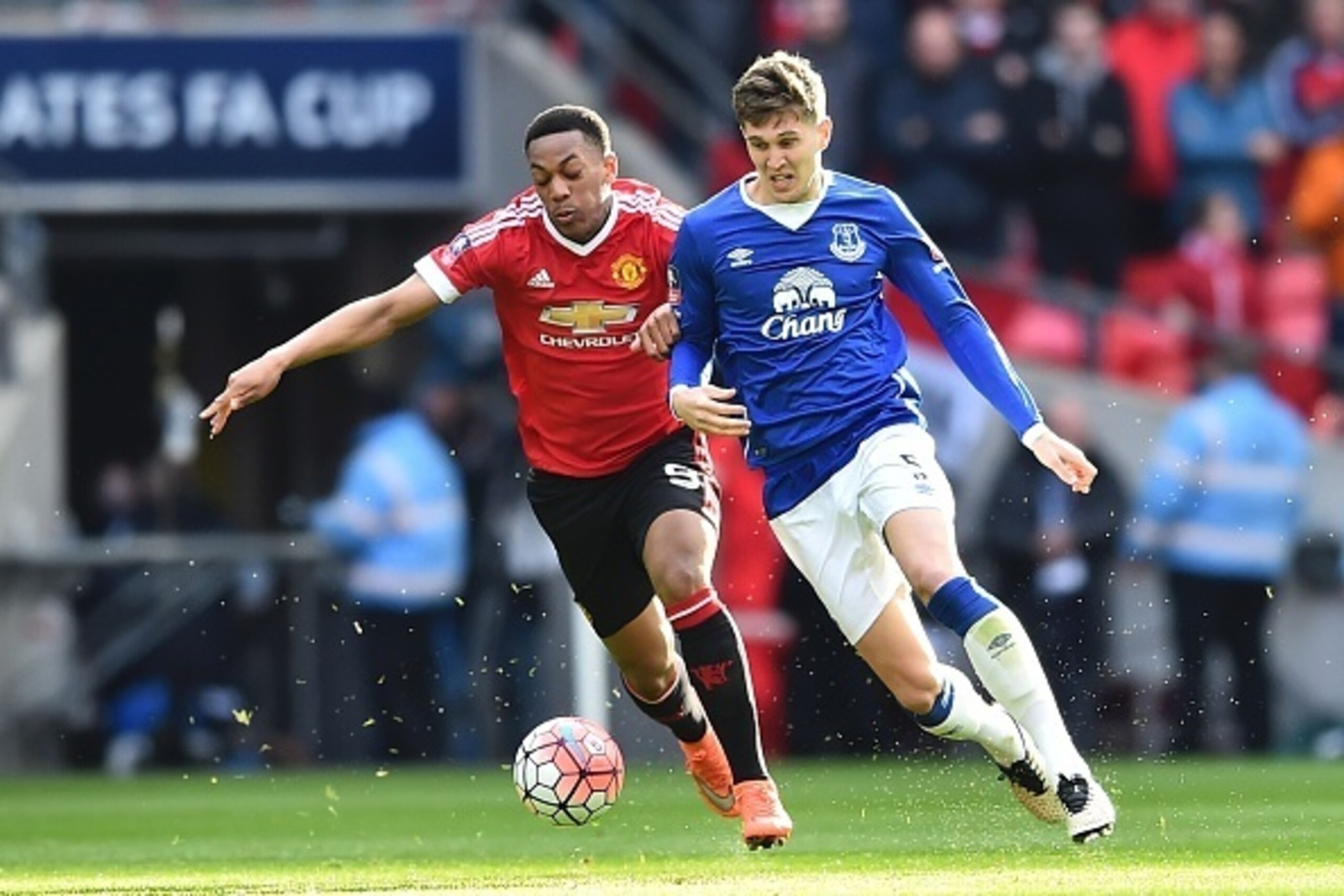 Manchester United's French striker Anthony Martial (L) tries to get in front of Everton's English defender John Stones (R) during the English FA Cup semi-final football match between Everton and Manchester United at Wembley Stadium in London on April 23, 