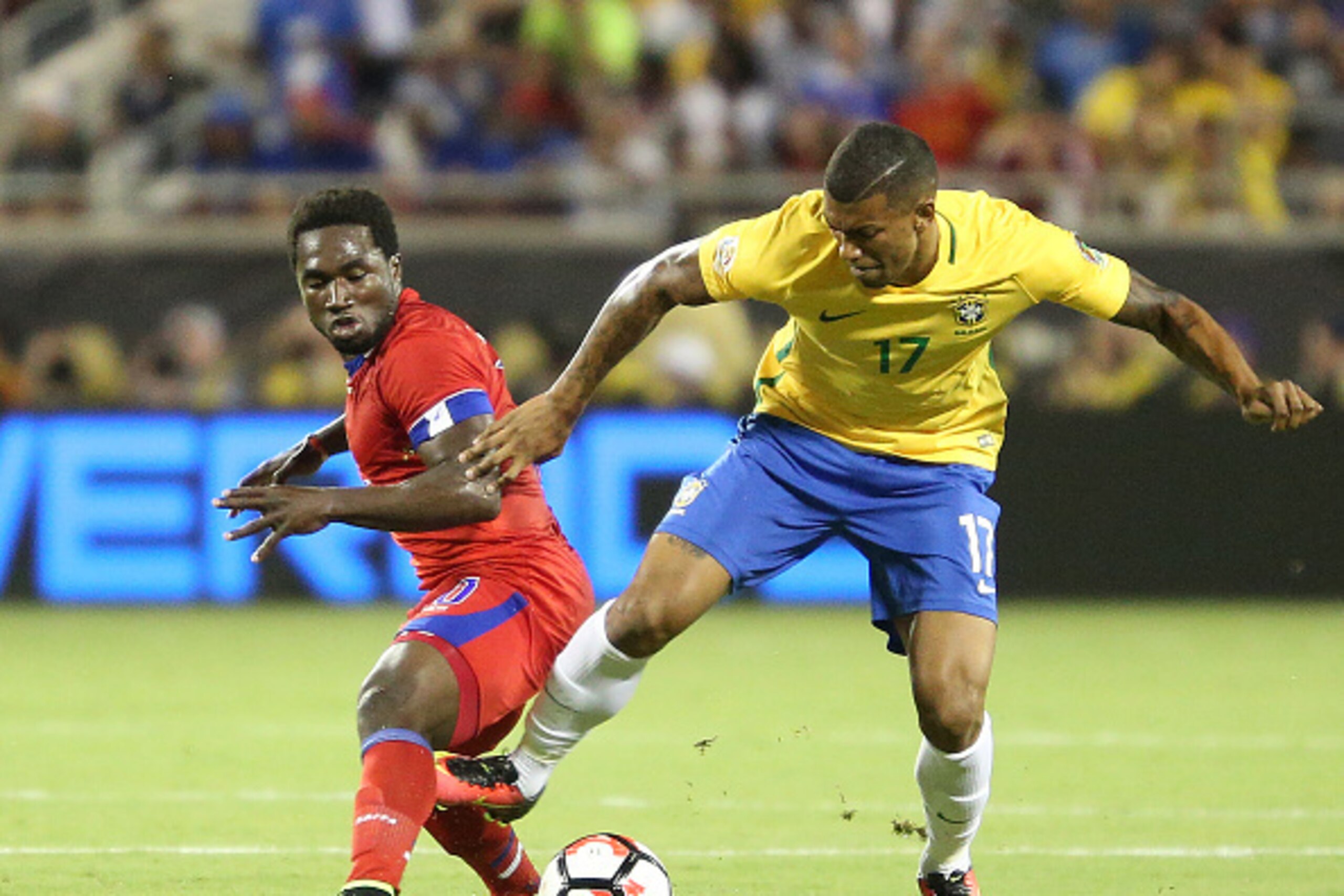 Brazil's Walace (R) vies for the ball with Haiti's Jeff Louis during a Copa America Centenario football match in Orlando, Florida, United States, on June 8, 2016.  / AFP / Gregg NEWTON        (Photo credit should read GREGG NEWTON/AFP/Getty Images)