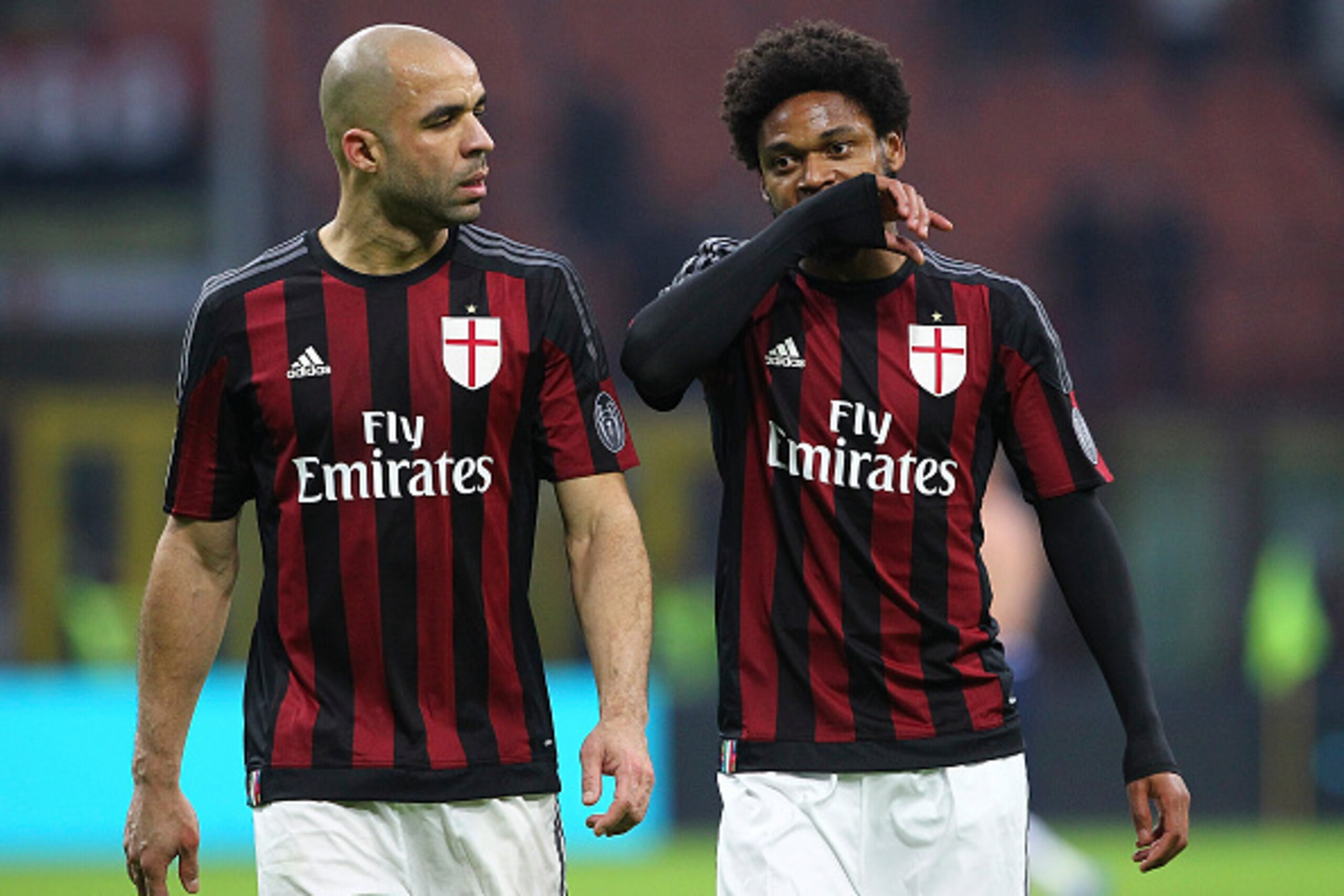 MILAN, ITALY - JANUARY 06:  Alex Dias da Costa and Luiz Adriano of AC Milan show their dejection at the end of the Serie A match between AC Milan and Bologna FC at Stadio Giuseppe Meazza on January 6, 2016 in Milan, Italy.  (Photo by Marco Luzzani/Getty I