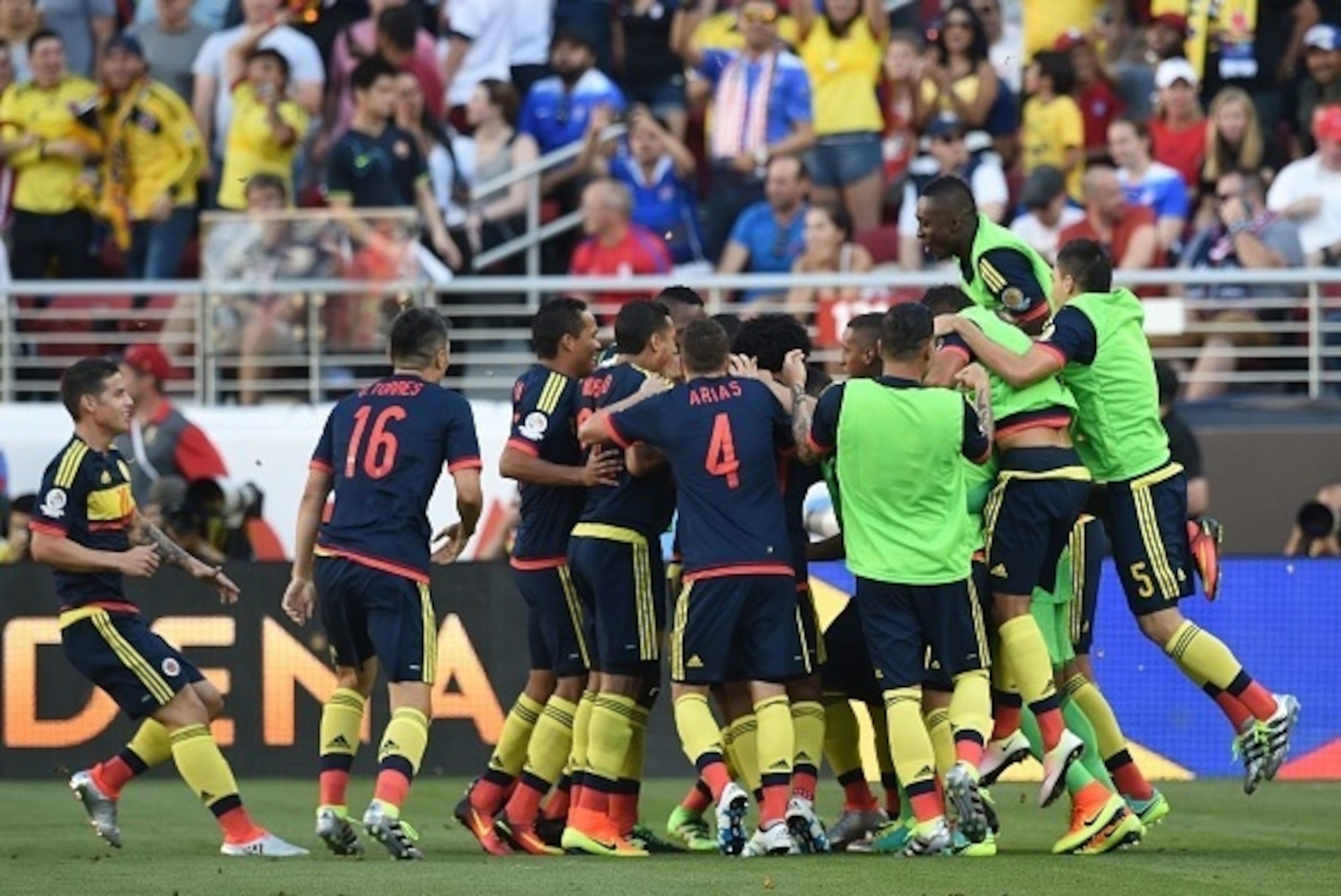 Colombia's players celebrate after teammate Cristian Zapata (covered) scored against the USA during the Copa America Centenario football tournament match in Santa Clara, California, United States, on June 3, 2016. / AFP / MARK RALSTON        (Photo credit