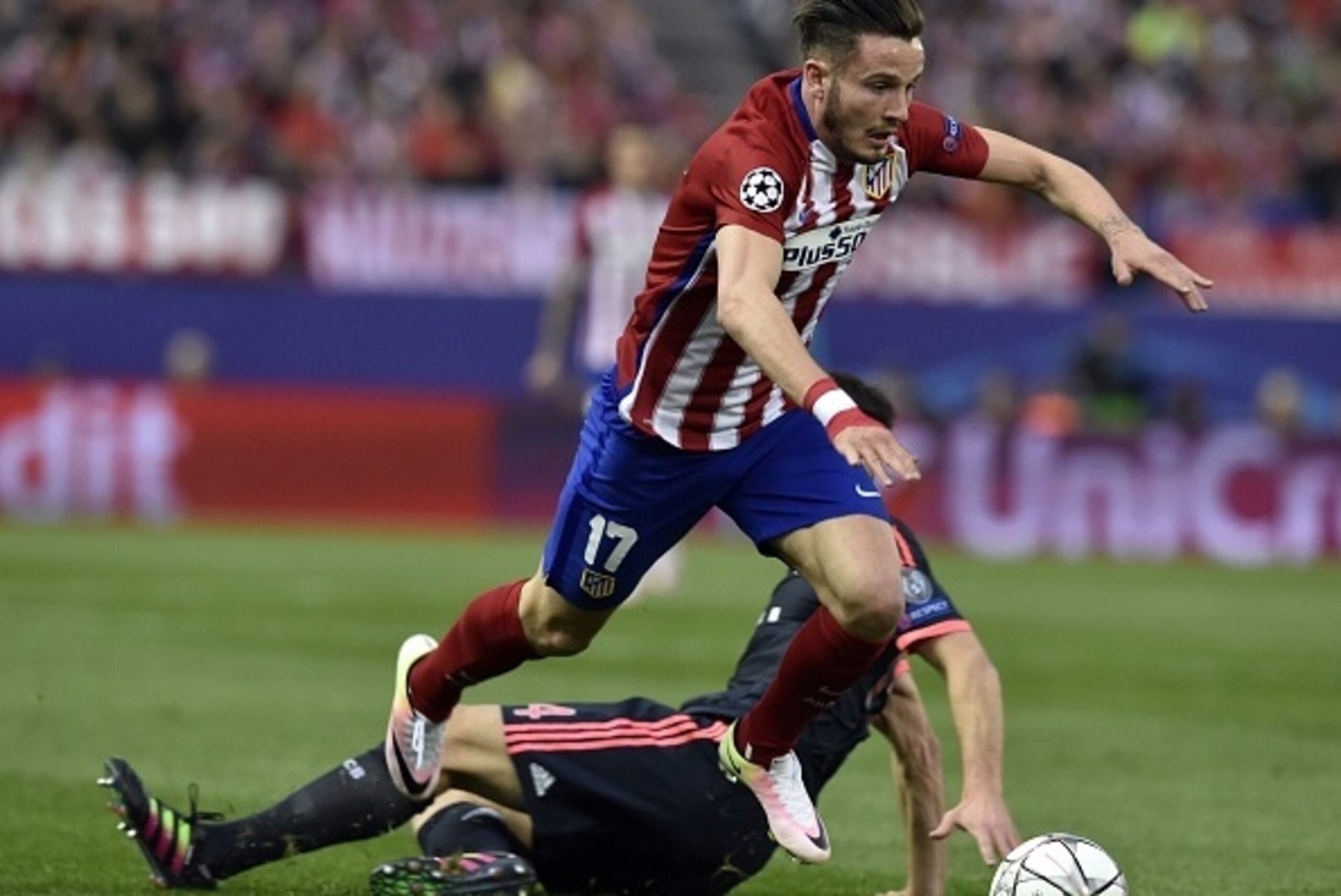 Atletico Madrid's midfielder Saul Niguez jumps over another player during the UEFA Champions League semi-final first leg football match Club Atletico de Madrid vs Bayern Munich at the Vicente Calderon stadium in Madrid on April 27, 2016. / AFP / GERARD JU
