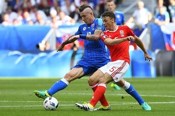 Slovakia's midfielder Juraj Kucka vies for the ball with Wales' defender James Chester during the Euro 2016 group B football match between Wales and Slovakia at the Stade de Bordeaux in Bordeaux on June 11, 2016. / AFP / Joe KLAMAR        (Photo credit sh