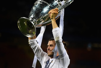 MILAN, ITALY - MAY 28:  Gareth Bale of Real Madrid celebrates with the trophy after victory in the UEFA Champions League Final match between Real Madrid and Club Atletico de Madrid at Stadio Giuseppe Meazza on May 28, 2016 in Milan, Italy.  (Photo by Laur