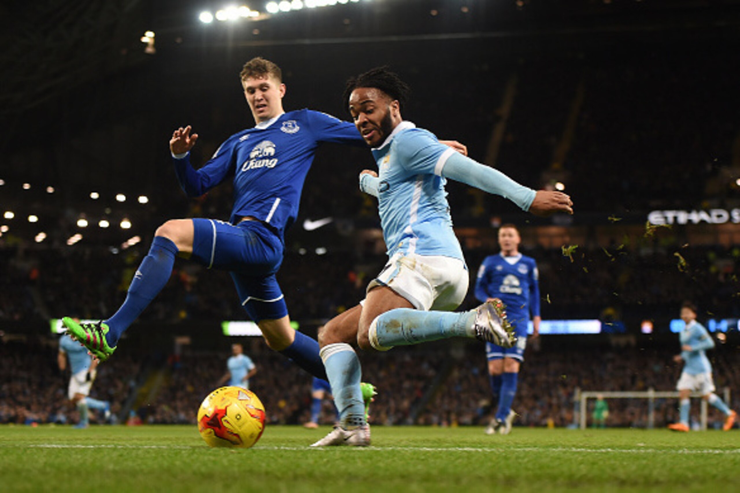 Everton's English defender John Stones (L) vies with Manchester City's English midfielder Raheem Sterling during the English League Cup semi-final second leg football match between Manchester City and Everton the Etihad Stadium in Manchester, north west E