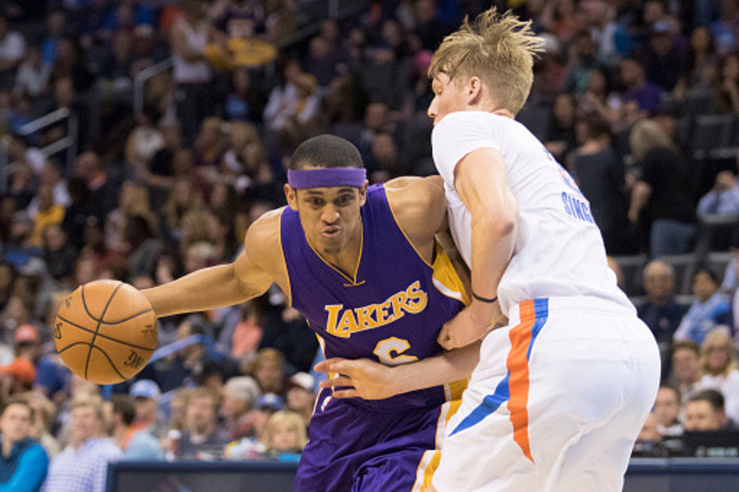 OKLAHOMA CITY, OK - APRIL 11: Jordan Clarkson #6 of the Los Angeles Lakers tries to drive around Kyle Singler #5 of the Oklahoma City Thunder during the fourth quarter of a NBA game at the Chesapeake Energy Arena on April 22, 2016 in Oklahoma City, Oklaho
