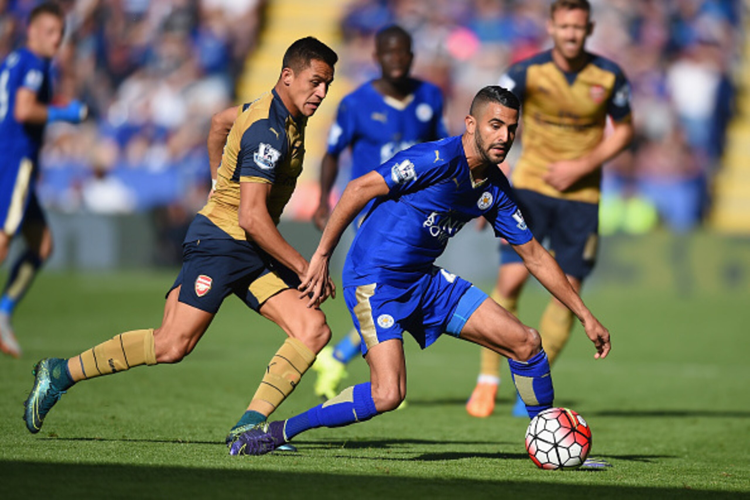 LEICESTER, ENGLAND - SEPTEMBER 26: Riyad Mahrez of Leicester City and Alexis Sanchez of Arsenal compete for the ball during the Barclays Premier League match between Leicester City and Arsenal at The King Power Stadium on September 26, 2015 in Leicester, 