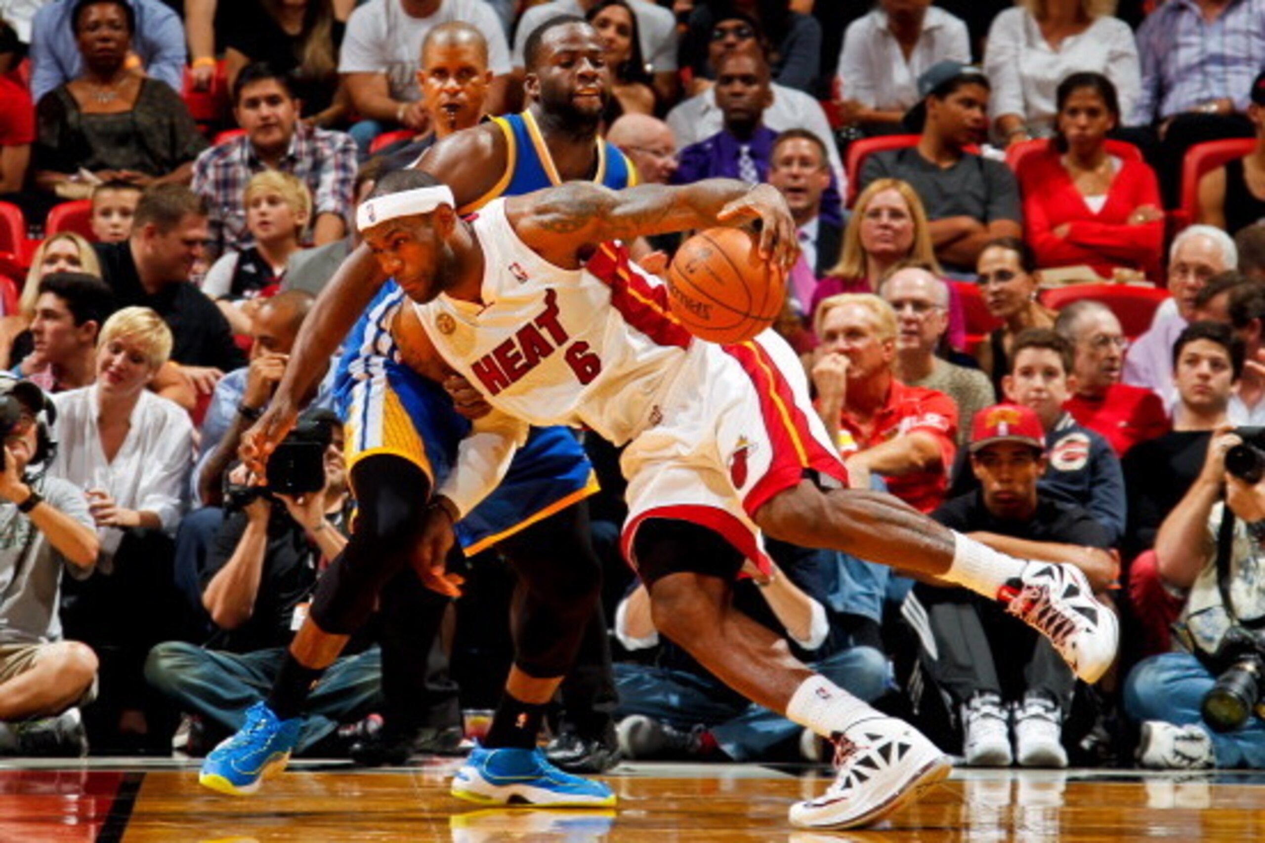 MIAMI, FL - DECEMBER 12: LeBron James #6 of the Miami Heat drives against Draymond Green #23 of the Golden State Warriors on December 12, 2012 at American Airlines Arena in Miami, Florida. NOTE TO USER: User expressly acknowledges and agrees that, by down
