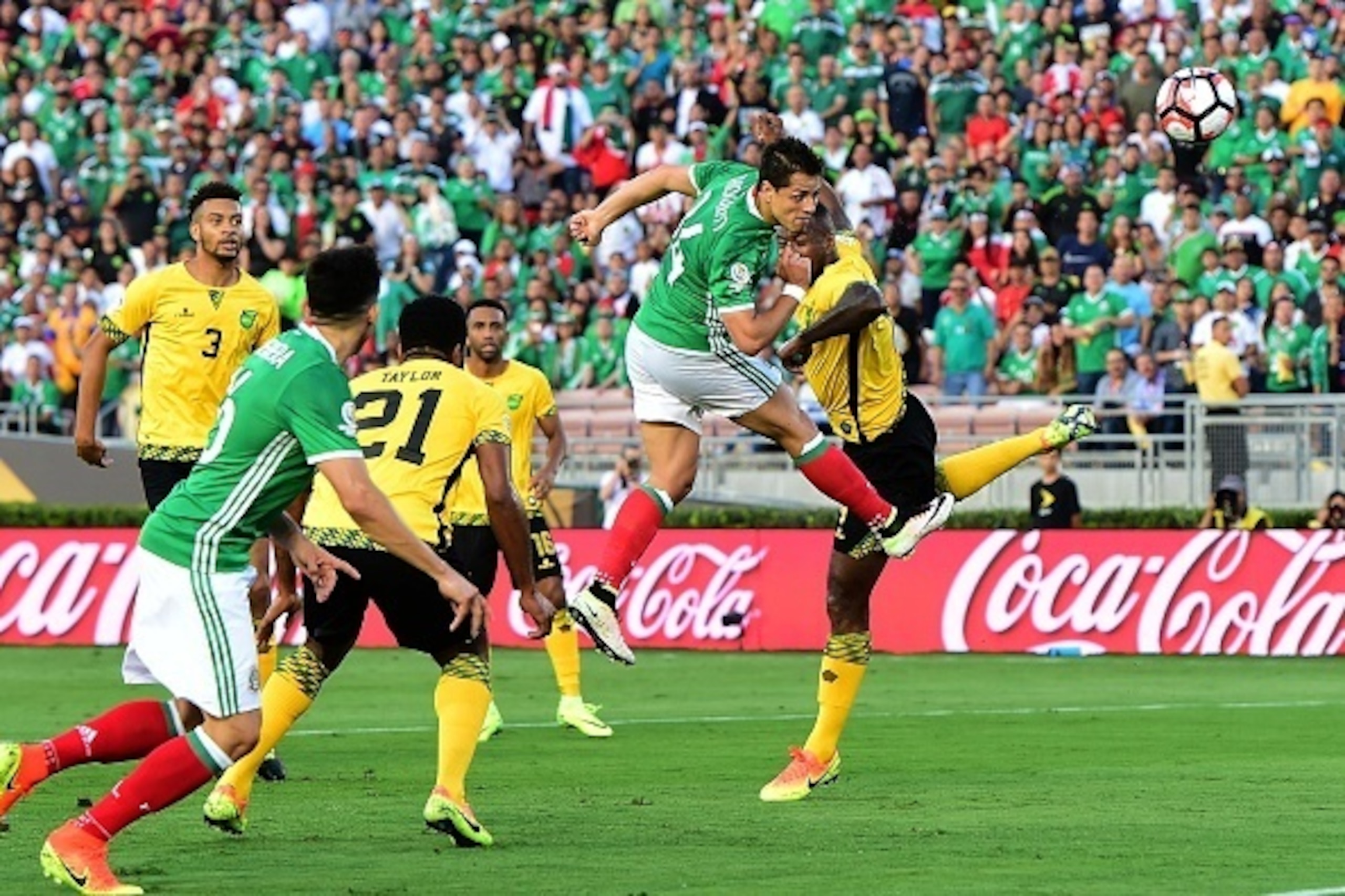 TOPSHOT - Mexico's Javier 'Chicharito' Hernandez (2-R) scores a header against Jamaica during their Copa America Centenario football tournament match in Pasadena, California, United States, on June 9, 2016.  / AFP / Frederic J. Brown        (Photo credit 