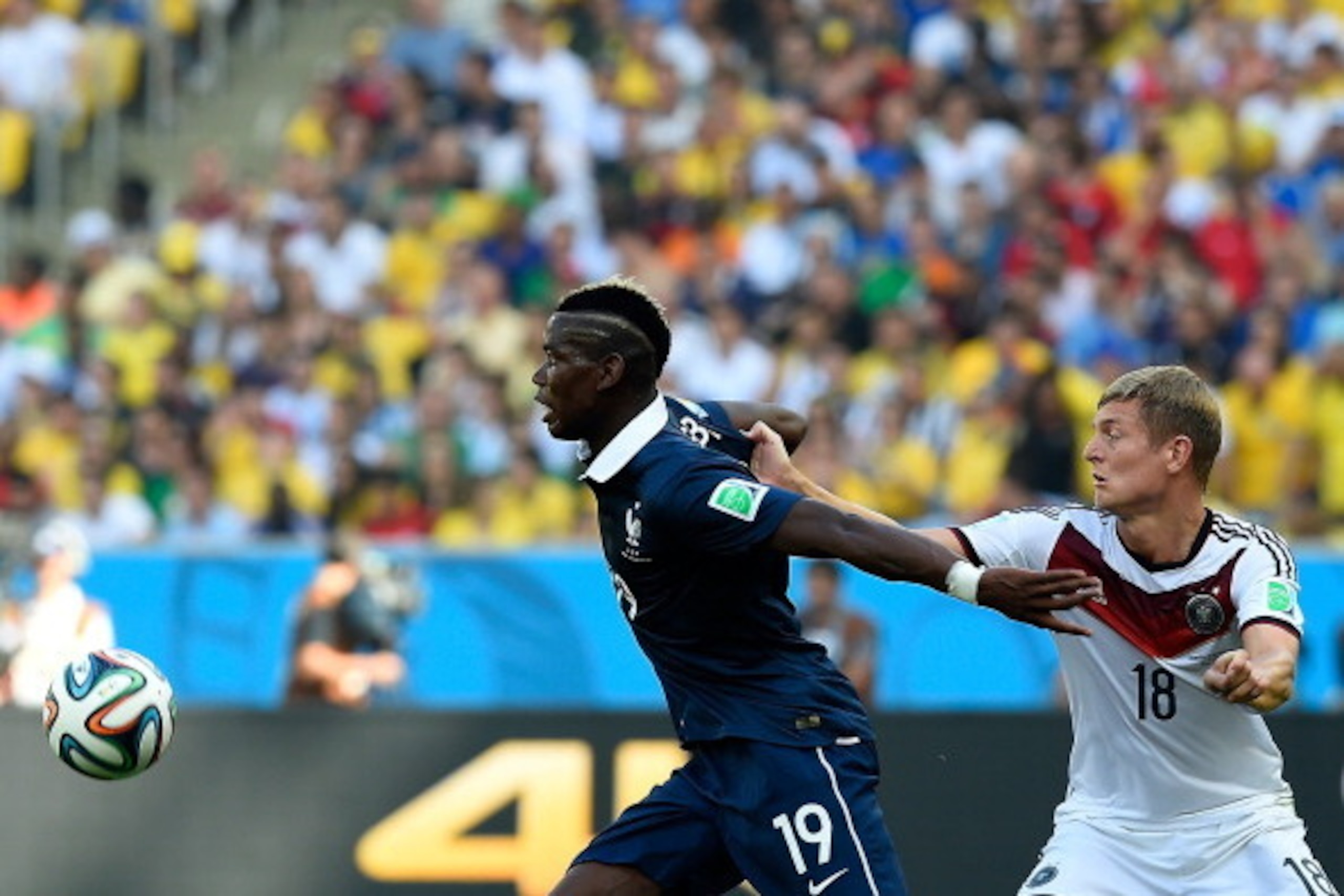 France's midfielder Paul Pogba (L) and Germany's midfielder Toni Kroos vie for the ball during the quarter-final football match between France and Germany at the Maracana Stadium in Rio de Janeiro during the 2014 FIFA World Cup on July 4, 2014. AFP PHOTO 
