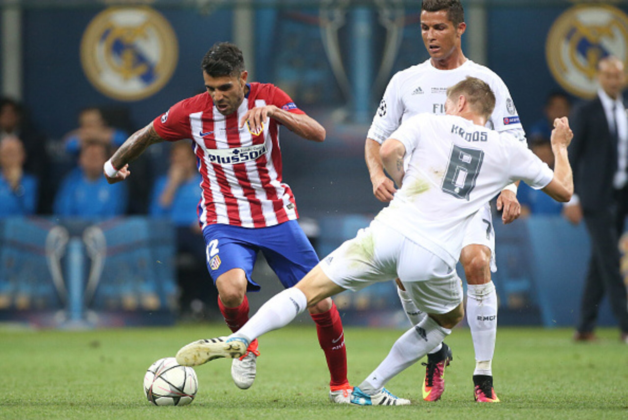 MILAN, ITALY - MAY 28: Augusto Fernandez of Atletico Madrid in action with Toni Kroos and Cristiano Ronaldo of Real Madrid during the UEFA Champions League final between Real Madrid and Club Atletico Madrid at Stadio Giuseppe Meazza, San Siro on May 28, 2