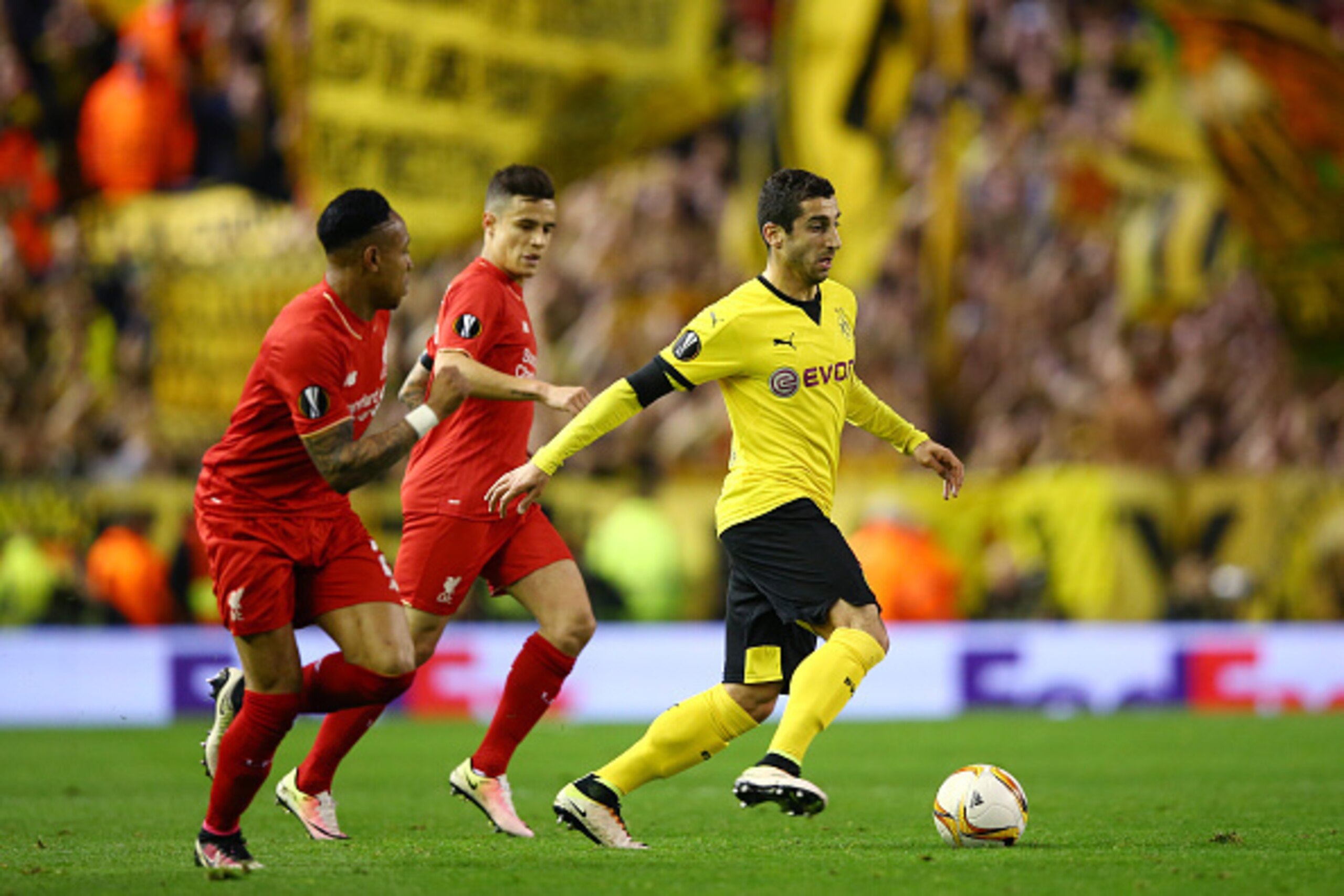 LIVERPOOL, ENGLAND - APRIL 14:  Henrikh Mkhitaryan of Borussia Dortmund is closed down by Nathaniel Clyne of Liverpool and Philippe Coutinho of Liverpool during the UEFA Europa League quarter final, second leg match between Liverpool and Borussia Dortmund