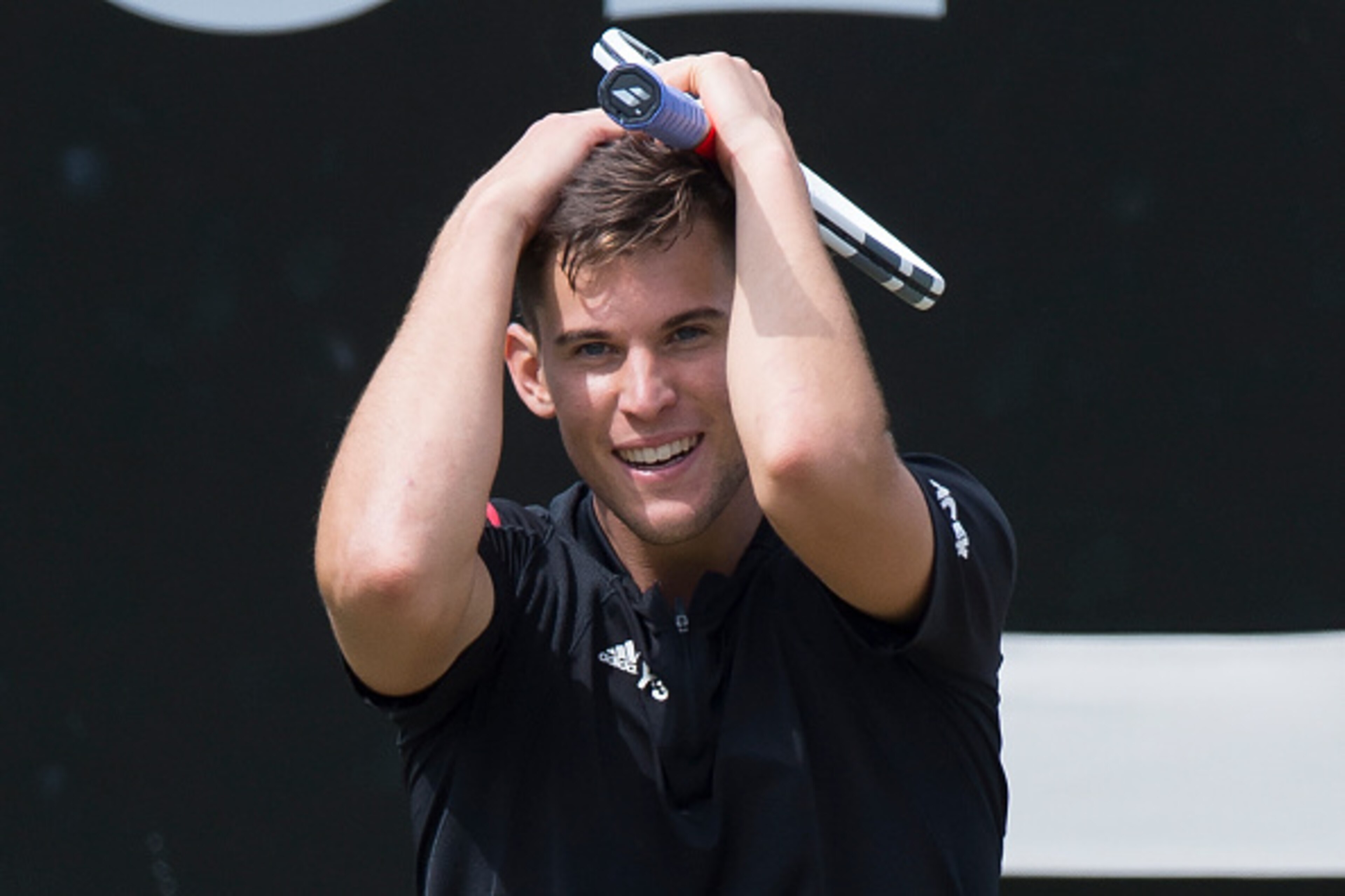 Austria's Dominic Thiem celebrates after winning against Switzerland's Roger Federer in their semifinal match at the ATP Mercedes Cup tennis tournament in Stuttgart, southwestern Germany, on June 11, 2016.  / AFP / THOMAS KIENZLE        (Photo credit shou