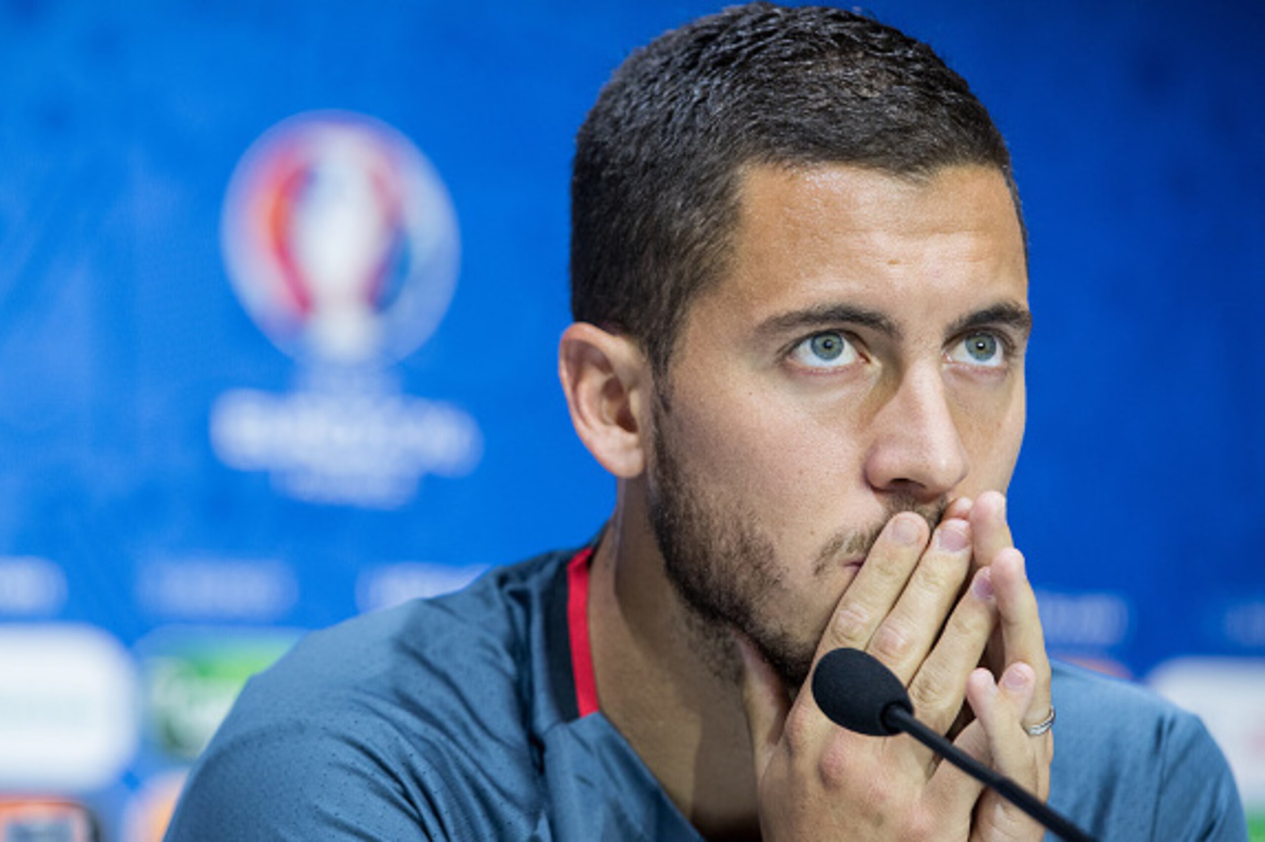 DECINES-CHARPIEU, FRANCE - JUNE 12:  In this handout image provided by UEFA, Eden Hazard of Belgium reacts during the Belgium press conference on June 12, 2016 in Decines-Charpieu, France. (Photo by Handout/UEFA via Getty Images)