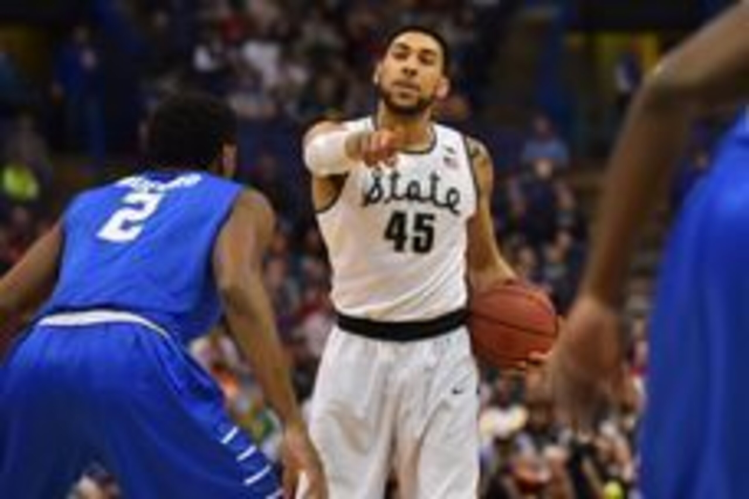 Mar 18, 2016; St. Louis, MO, USA; Michigan State Spartans guard Denzel Valentine (45) motions while guarded by Middle Tennessee Blue Raiders forward Perrin Buford (2) during the first half of the first round in the 2016 NCAA Tournament at Scottrade Center