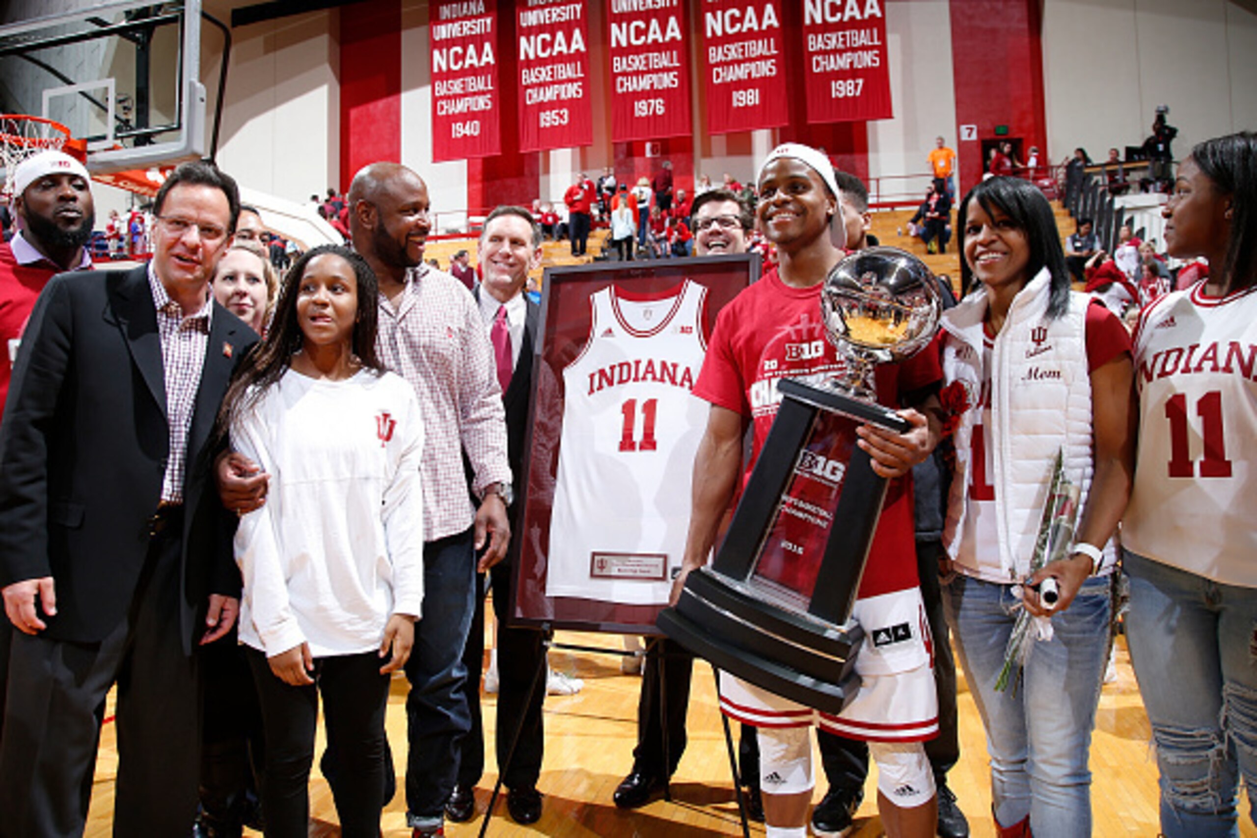 BLOOMINGTON, IN - MARCH 6: Yogi Ferrell #11 of the Indiana Hoosiers stands with his family and head coach Tom Crean while holding the Big Ten championship trophy on senior day following the game against the Maryland Terrapins at Assembly Hall on March 6, 
