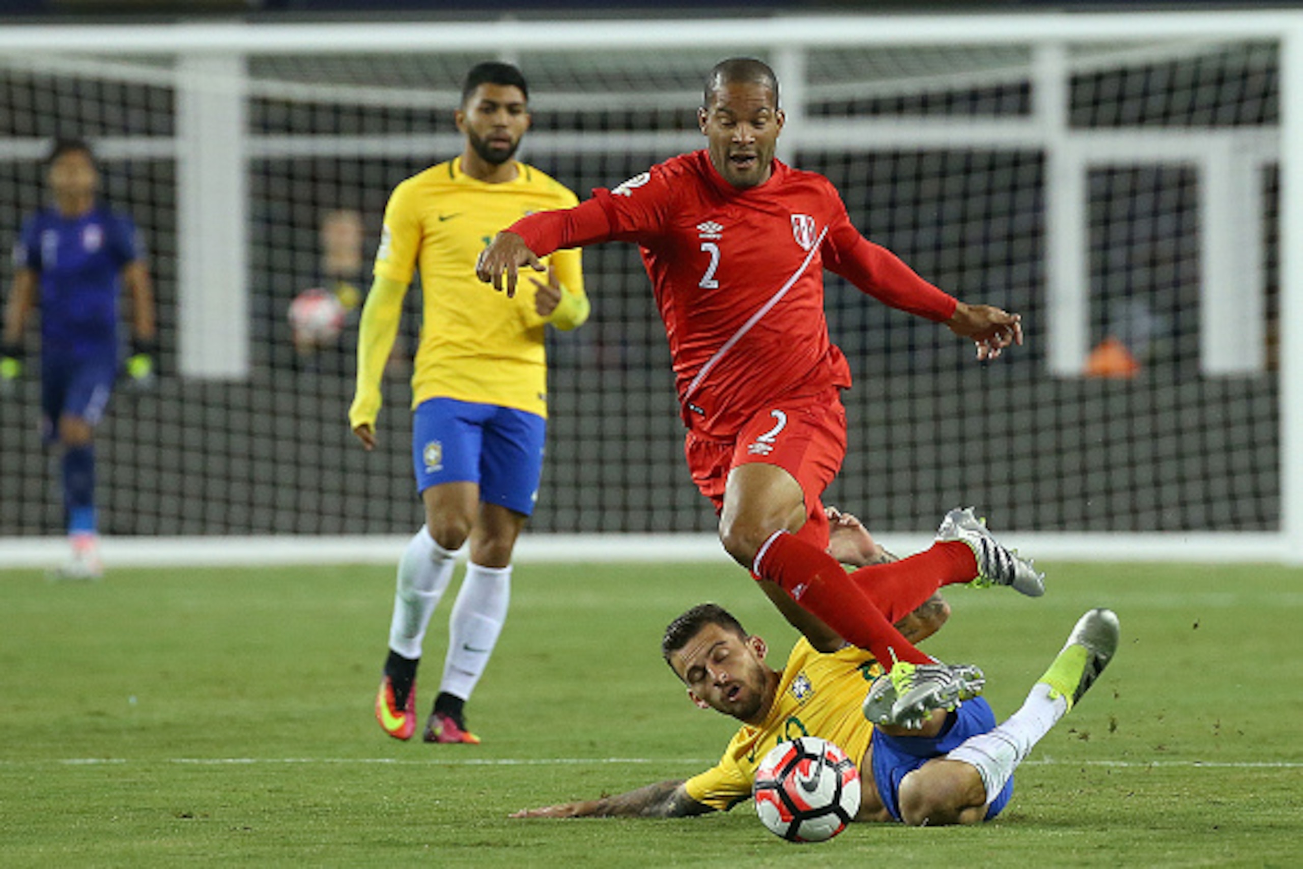FOXBORO, MA - JUNE 12: Alberto Rodriguez #2 of Peru leaps over Lucas Lima #10 of Brazil running for the ball in the first half during the 2016 Copa America Centenario Group B match against Brazil at Gillette Stadium on June 12, 2016 in Foxboro, Massachuse