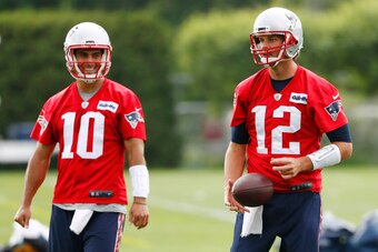 Jun 7, 2016; Foxborough, MA, USA; New England Patriots quarterback Tom Brady (12) and quarterback Jimmy Garoppolo (10) during mini camp at Gillette Stadium. Mandatory Credit: Winslow Townson-USA TODAY Sports