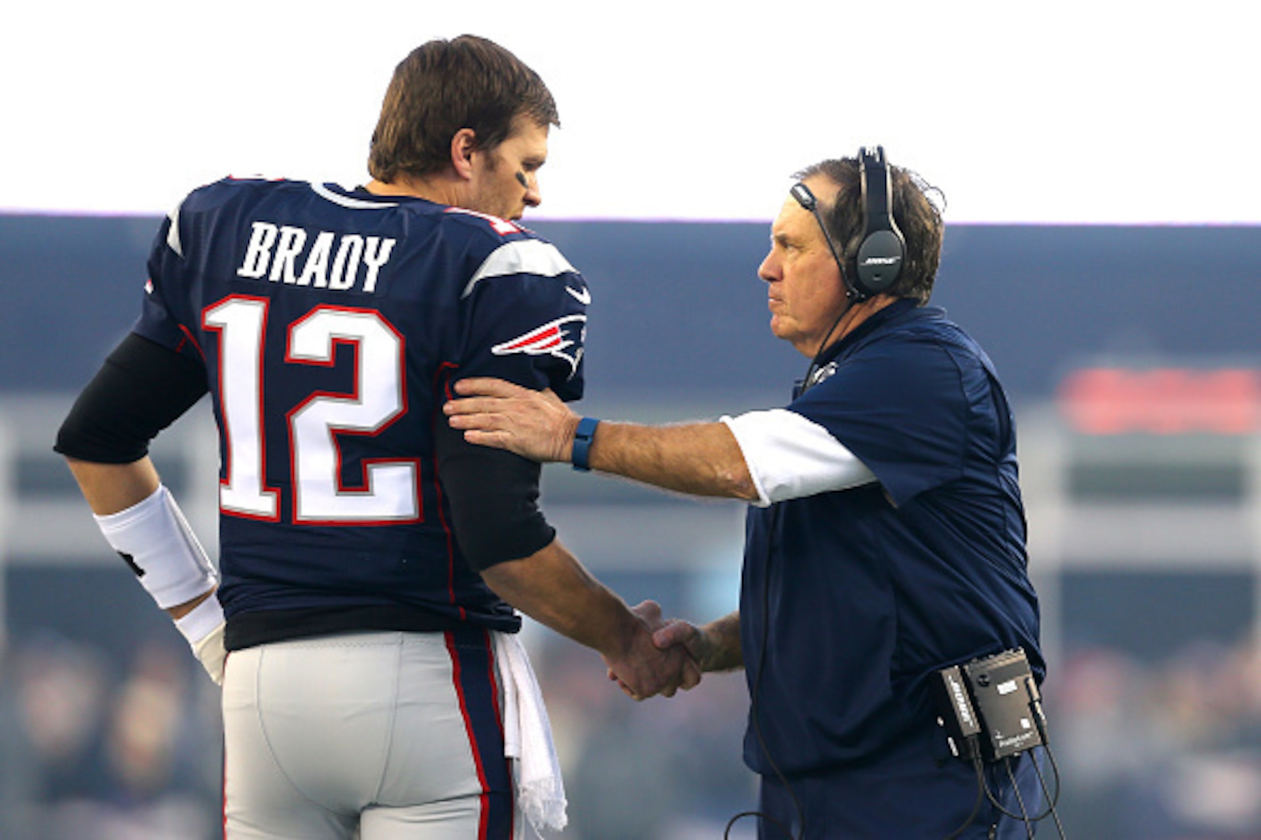 FOXBORO, MA - JANUARY 16: Tom Brady #12 and head coach Bill Belichick of the New England Patriots shake hands at the start of the AFC Divisional Playoff Game against the Kansas City Chiefs at Gillette Stadium on January 16, 2016 in Foxboro, Massachusetts.