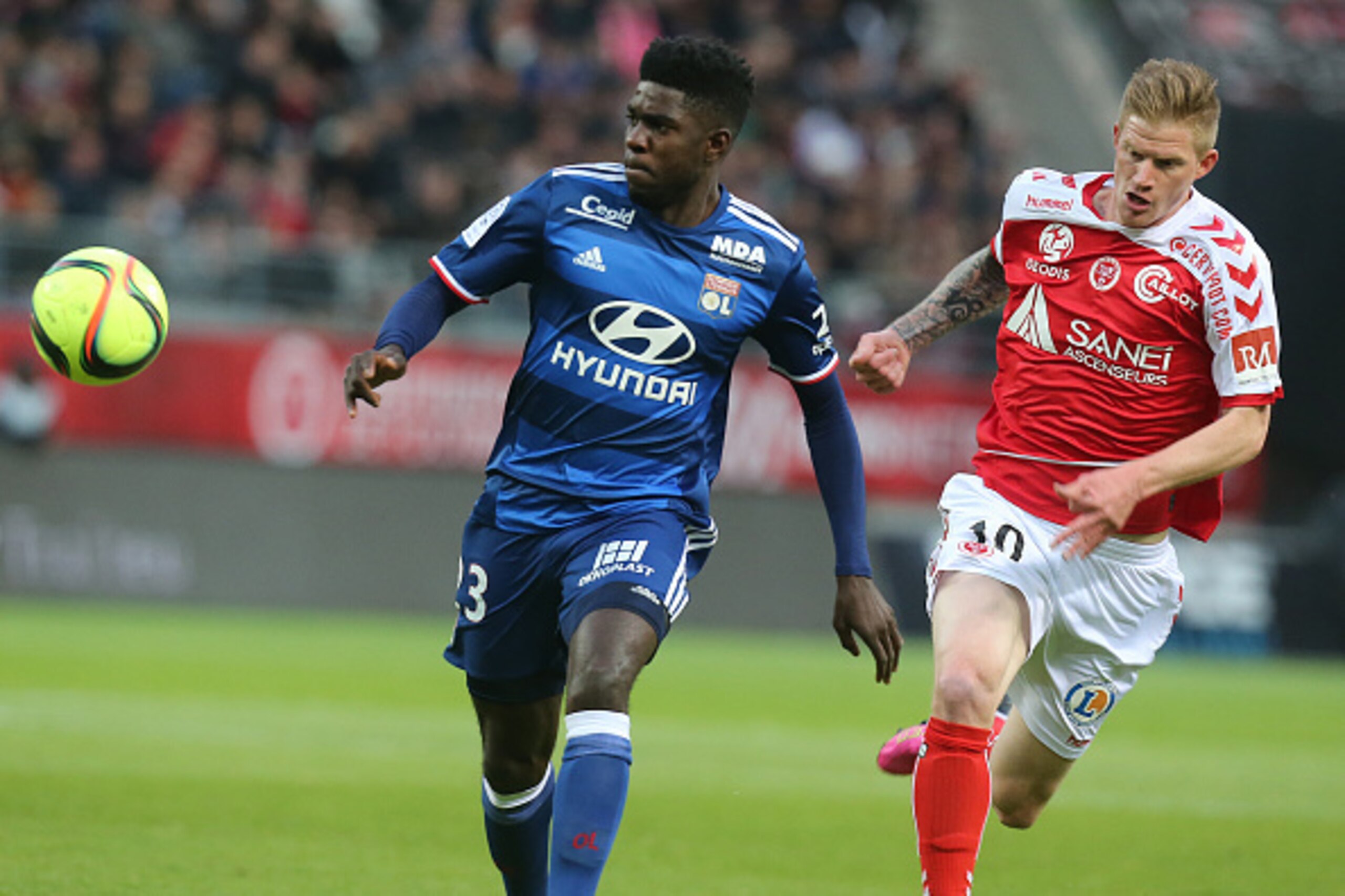 Reims' French forward Gaetan Charbonnier (R) vies with Lyon's French Cameroonian defender Samuel Umtiti (L) during the French Ligue 1 football match between Reims and Lyon on May 14, 2016 at the Auguste Delaune Stadium in Reims. PHOTO AFP / FRANCOIS NASCI
