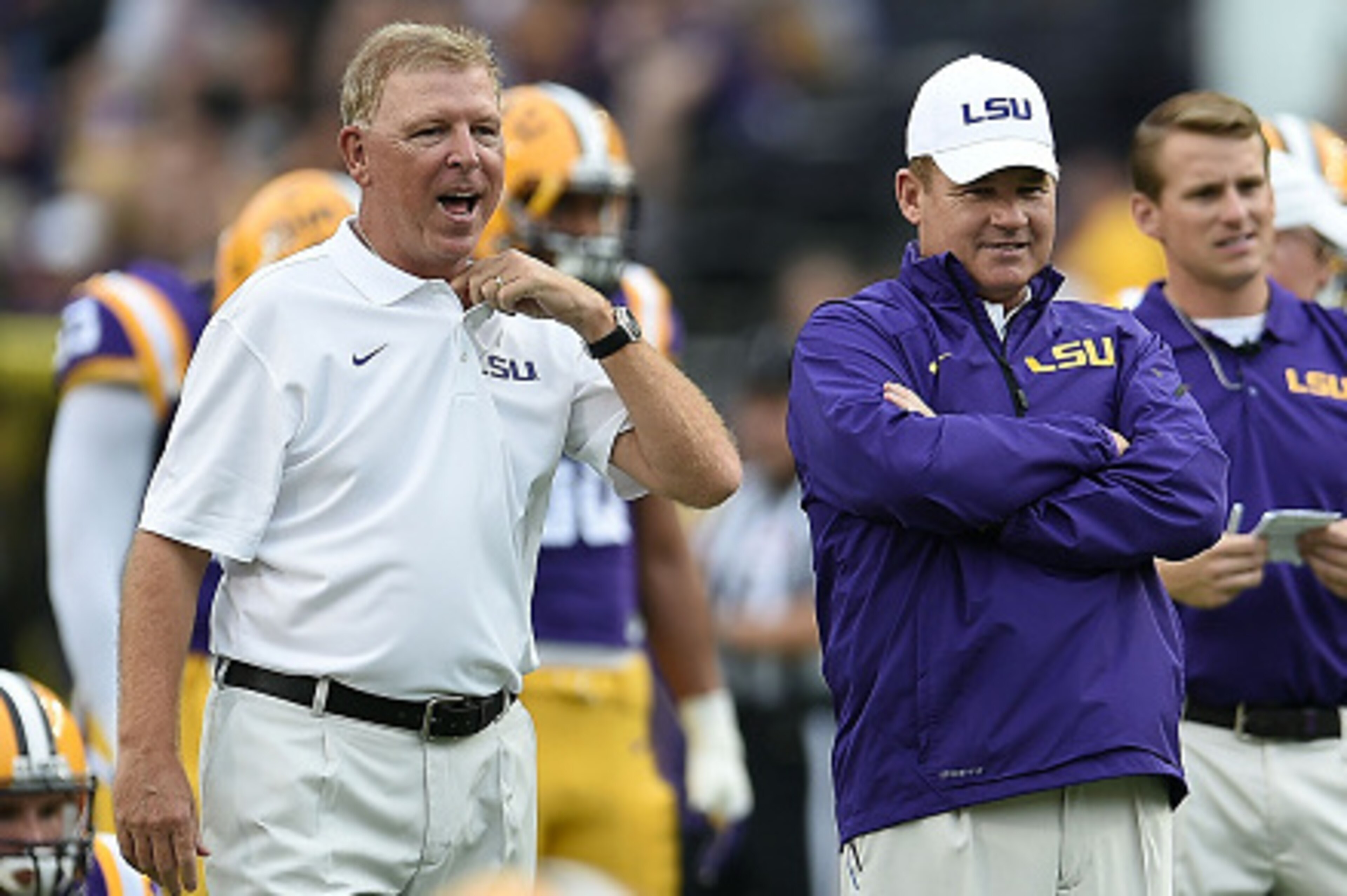 BATON ROUGE, LA - SEPTEMBER 27:  ( L to R ) Offensive coordinator Cam Cameron and head coach Les Miles of the LSU Tigers watch action prior to a game against the New Mexico State Aggies at Tiger Stadium on September 27, 2014 in Baton Rouge, Louisiana.  LS