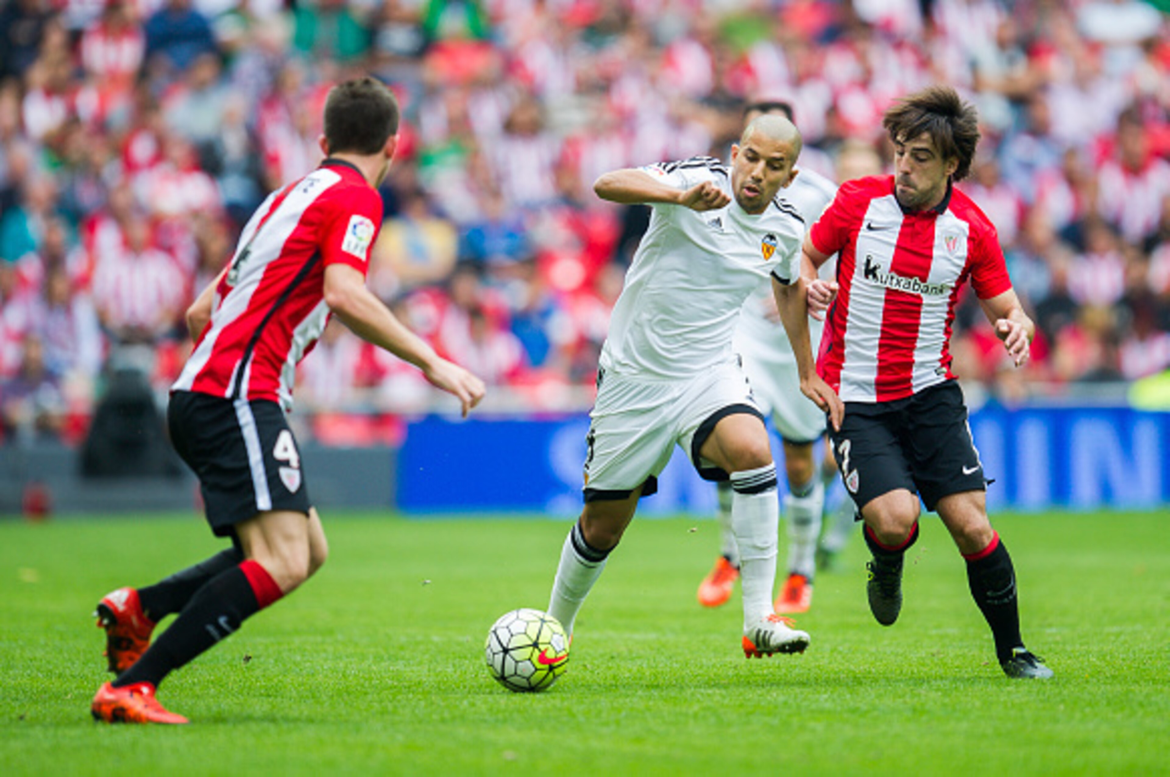 BILBAO, SPAIN - OCTOBER 04:  Sofiane Feghouli of Valencia CF duels for the ball with Benat Etxebarria of Athletic Club Bilbao during the La Liga match between Athletic Club Bilbao and Valencia CF at San Mames Stadium on October 4, 2015 in Bilbao, Spain.  