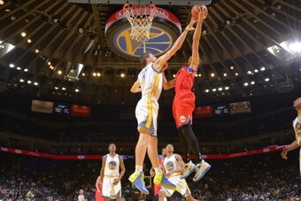 OAKLAND, CA - FEBRUARY 10: Ognjen Kuzmic #1 of the Golden State Warriors blocks the shot of Michael Carter-Williams #1 of the Philadelphia 76ers on February 10, 2014 at Oracle Arena in Oakland, California. NOTE TO USER: User expressly acknowledges and agr