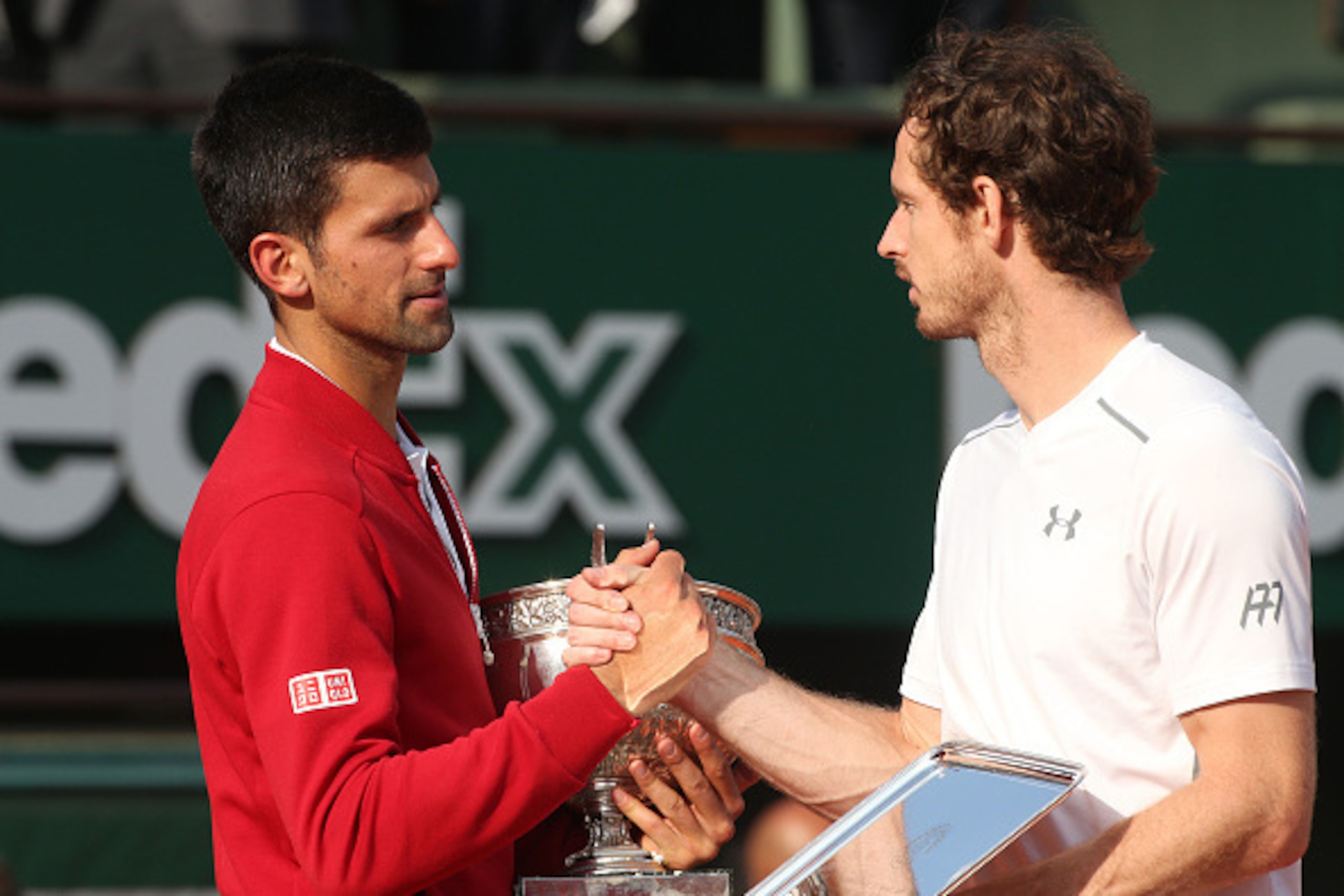 PARIS, FRANCE - JUNE 5: Winner Novak Djokovic of Serbia greets finalist Andy Murray of Great Britain during the trophy ceremony following the Men's Singles final match on day fifteen of the 2016 French Open at Roland-Garros stadium on June 5, 2016 in Pari