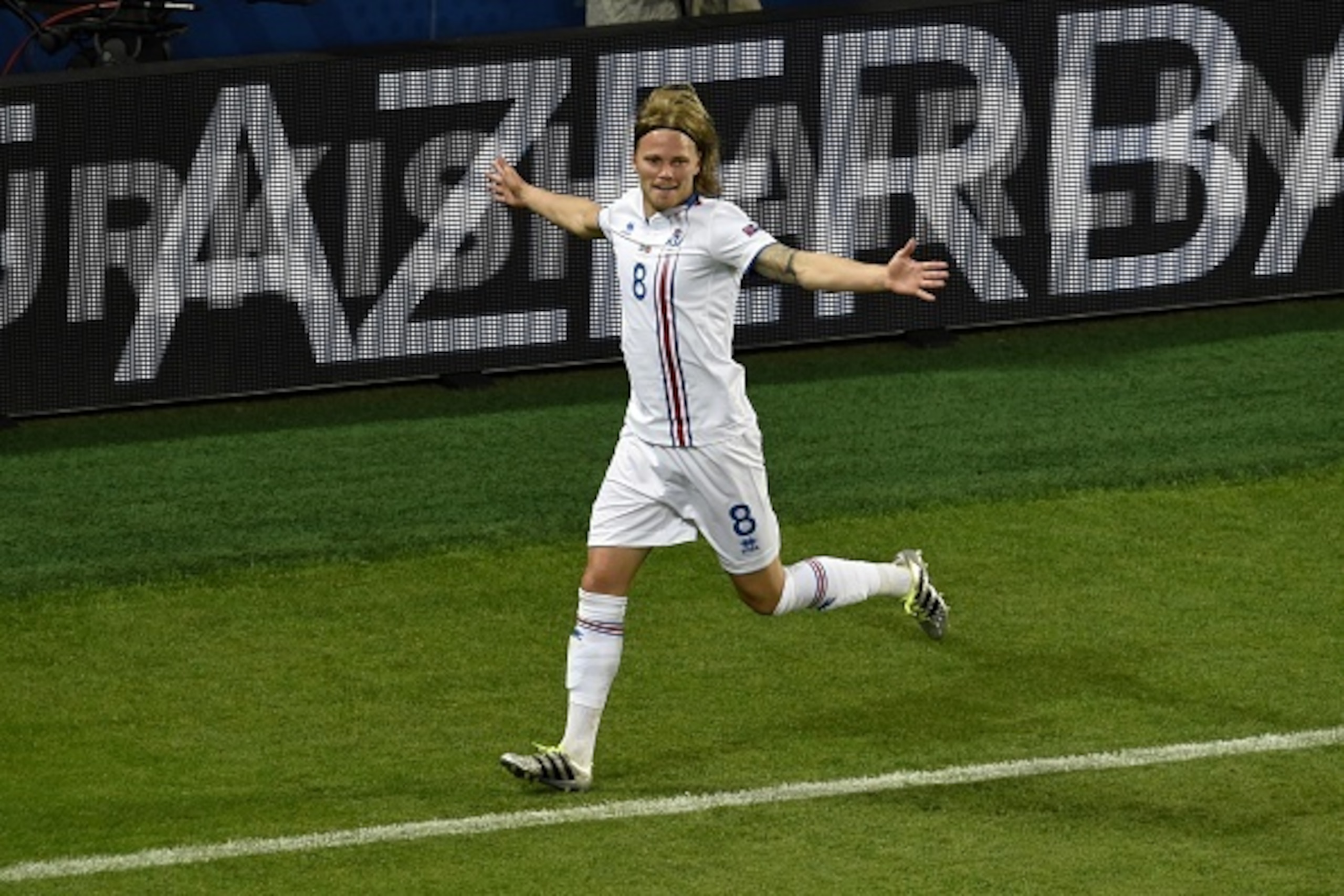 Iceland's midfielder Birkir Bjarnason celebrates the team's first goal during the Euro 2016 group F football match between Portugal and Iceland at the Geoffroy-Guichard stadium in Saint-Etienne on June 14, 2016. / AFP / JEAN-PHILIPPE KSIAZEK        (Photo