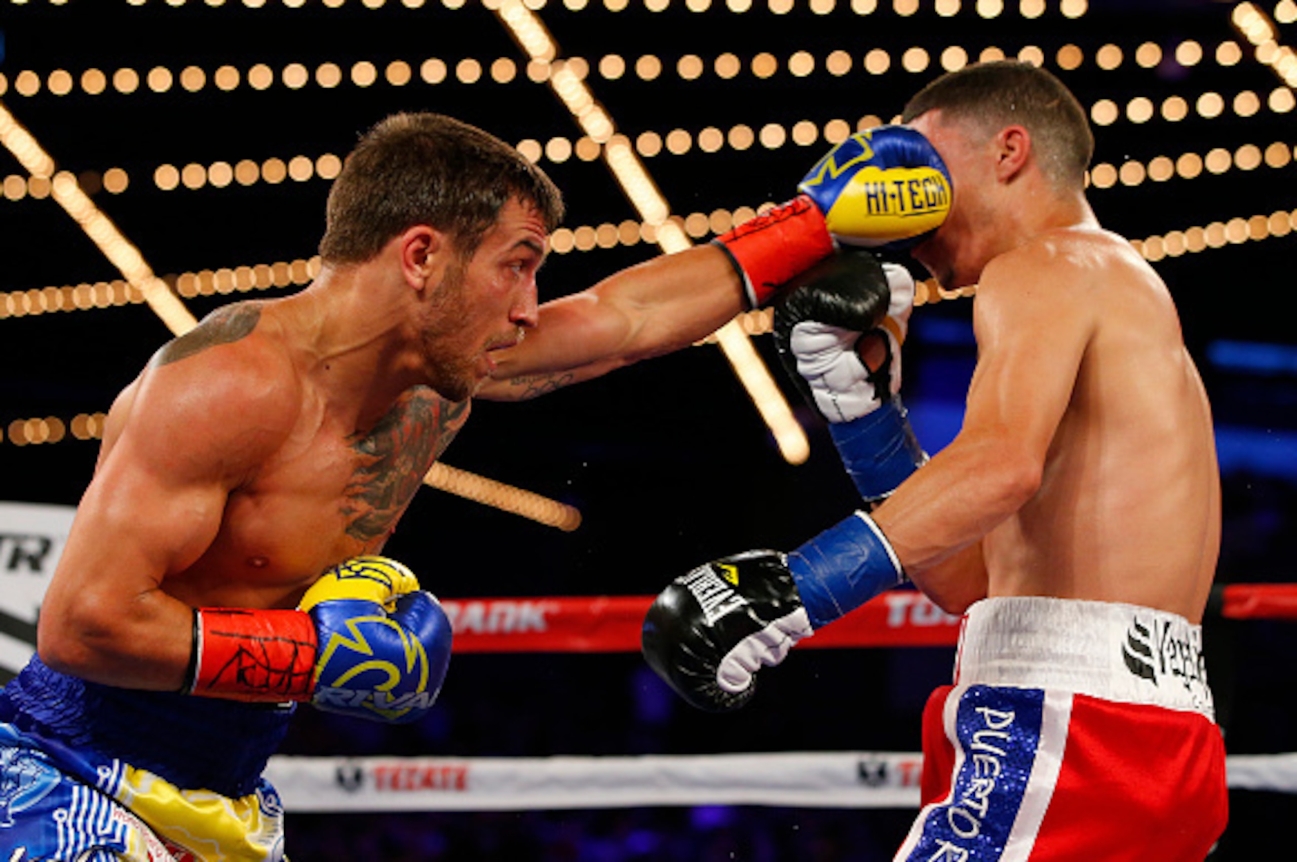 NEW YORK, NY - JUNE 11: Vasyl Lomachenko, left, lands a left punch to the face of Roman Martinez during their Junior Lightweight WBO World Championship bout on June 11, 2016 at the Theater at Madison Square Garden in New York City. Lomachenko won by a kno