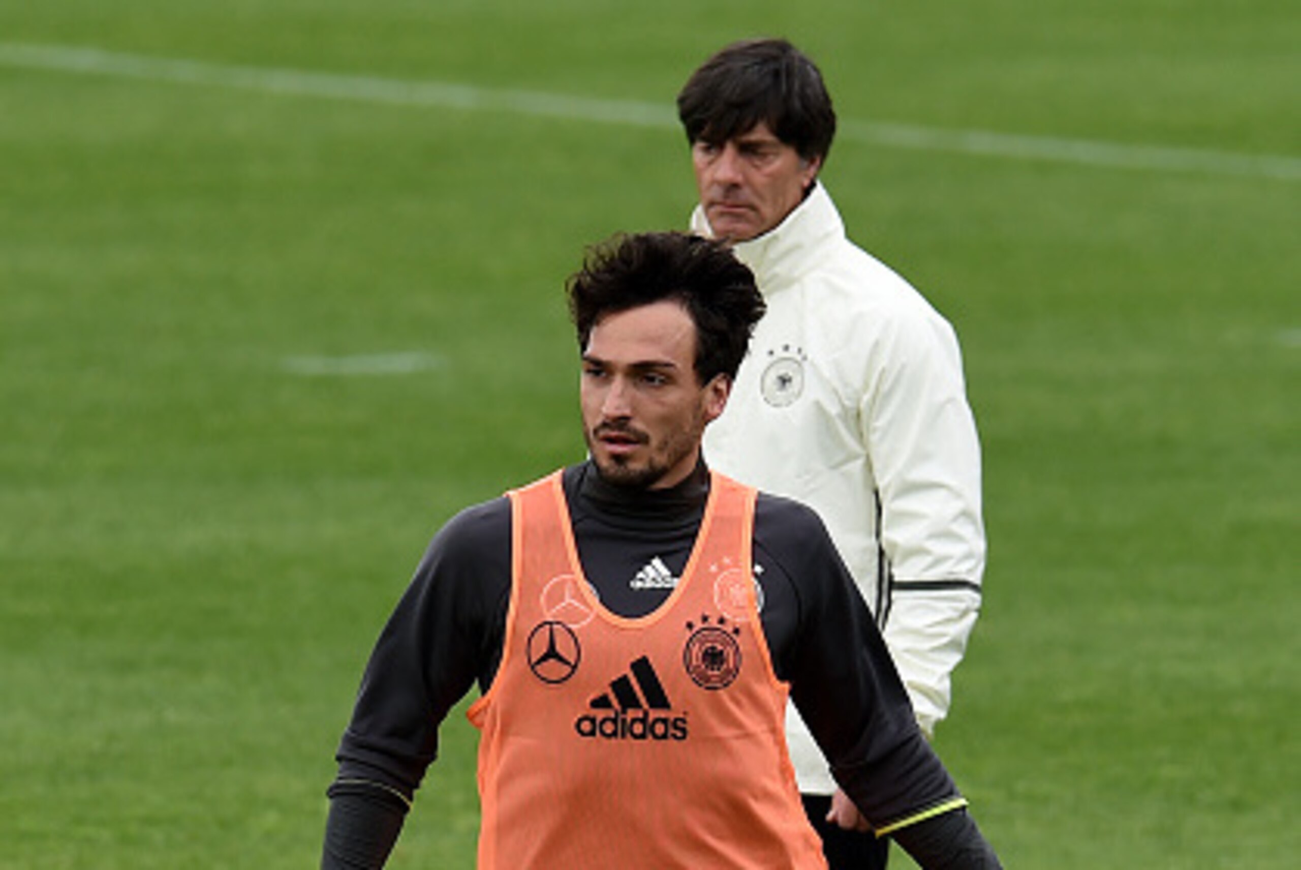 Germany's defender Mats Hummels warms up next to Germany's coach Joachim Loew during a training session of Germany's national football team at their training grounds in Evian-les-Bains, south-eastern France, on June 14, 2016, during the Euro 2016 football