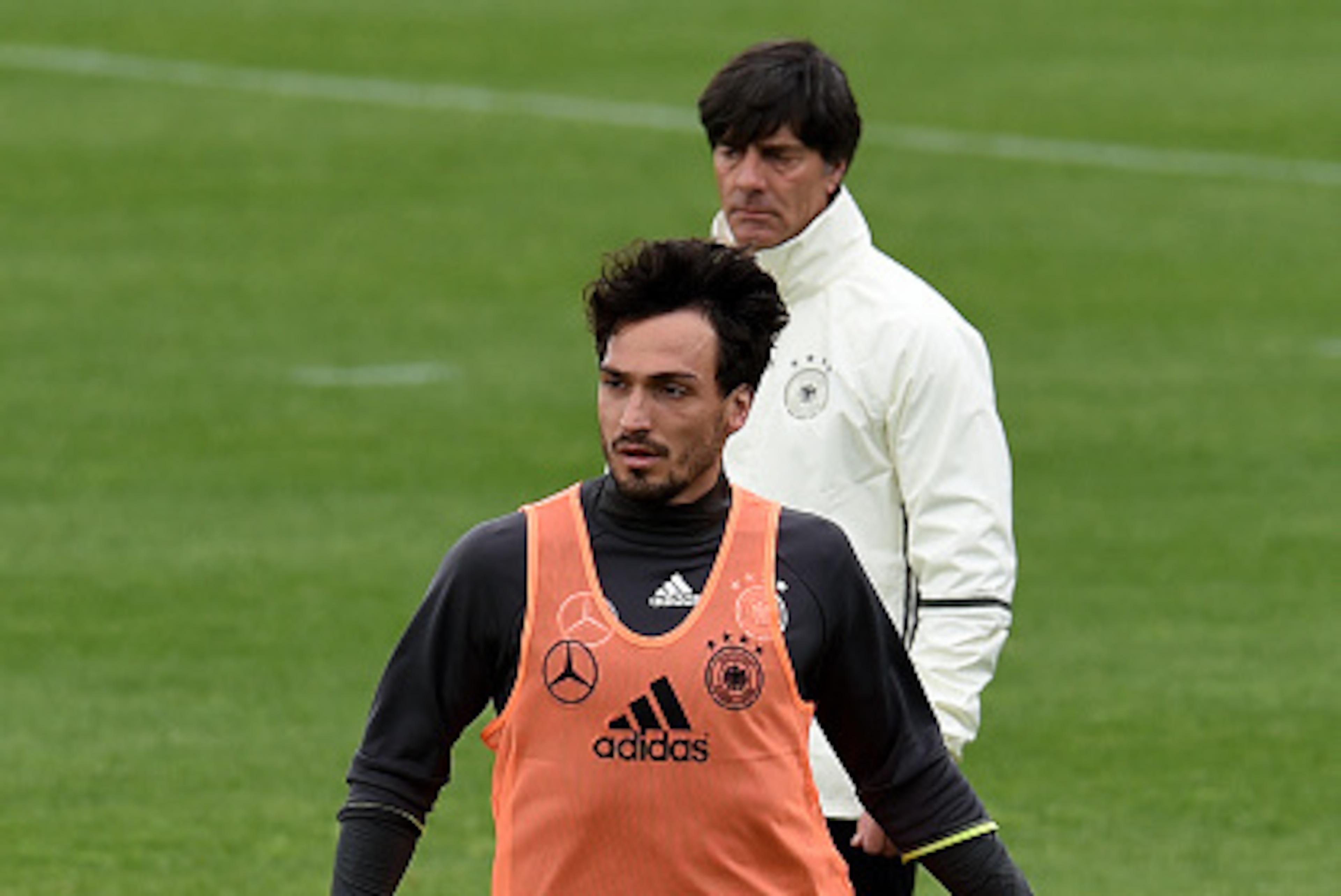 Germany's defender Mats Hummels warms up next to Germany's coach Joachim Loew during a training session of Germany's national football team at their training grounds in Evian-les-Bains, south-eastern France, on June 14, 2016, during the Euro 2016 football