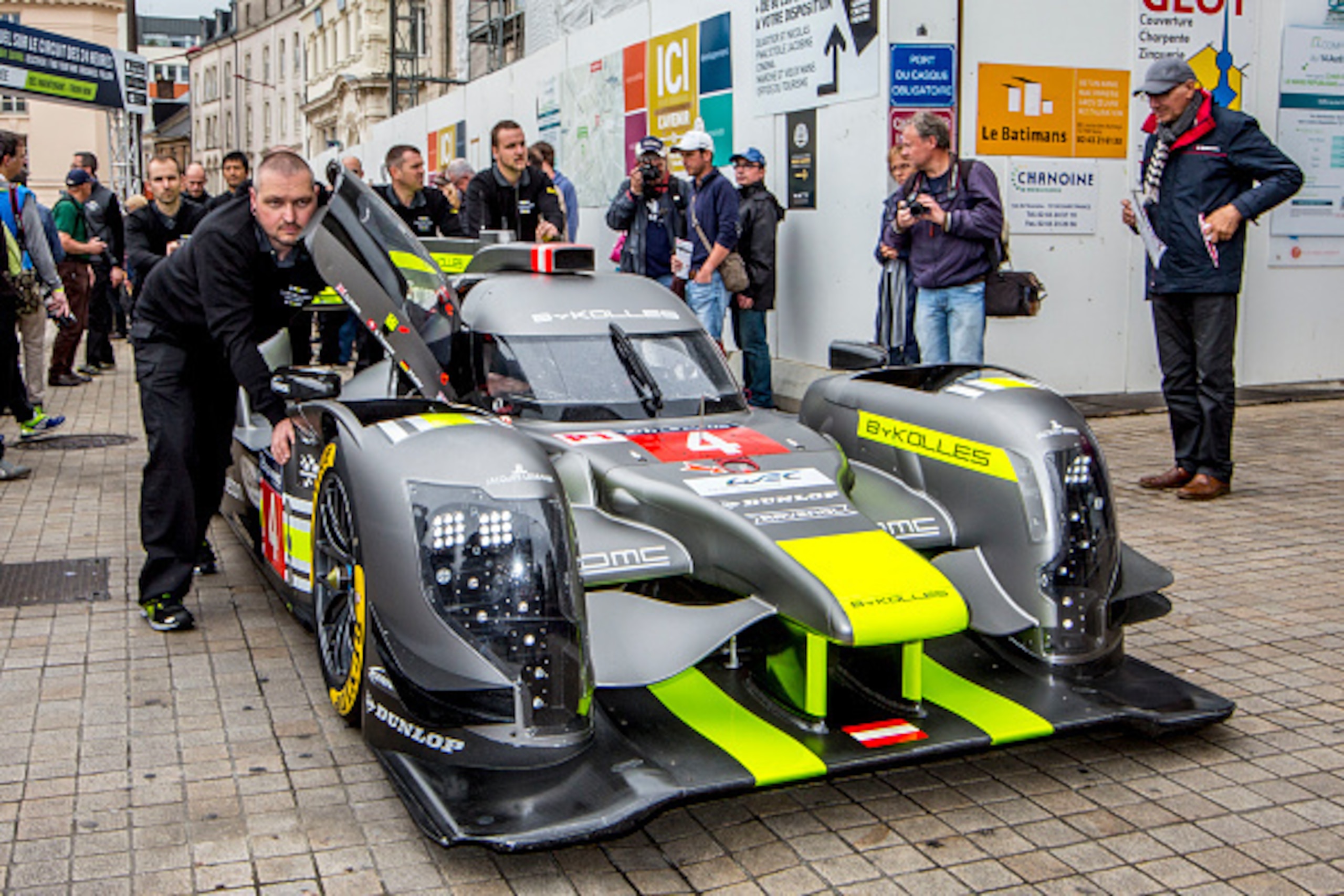 LE MANS, FRANCE - JUNE 13:  Crewmen push the #4 CLM P1/01 AER of  Simon Trummer, of Switzerland, Oliver Webb, Great Britain, and Pierre Kaffer, of Germany,  during scrutineering for the Le Mans 24 Hour Race on June 13, 2016 in Le Mans, France.  (Photo by 