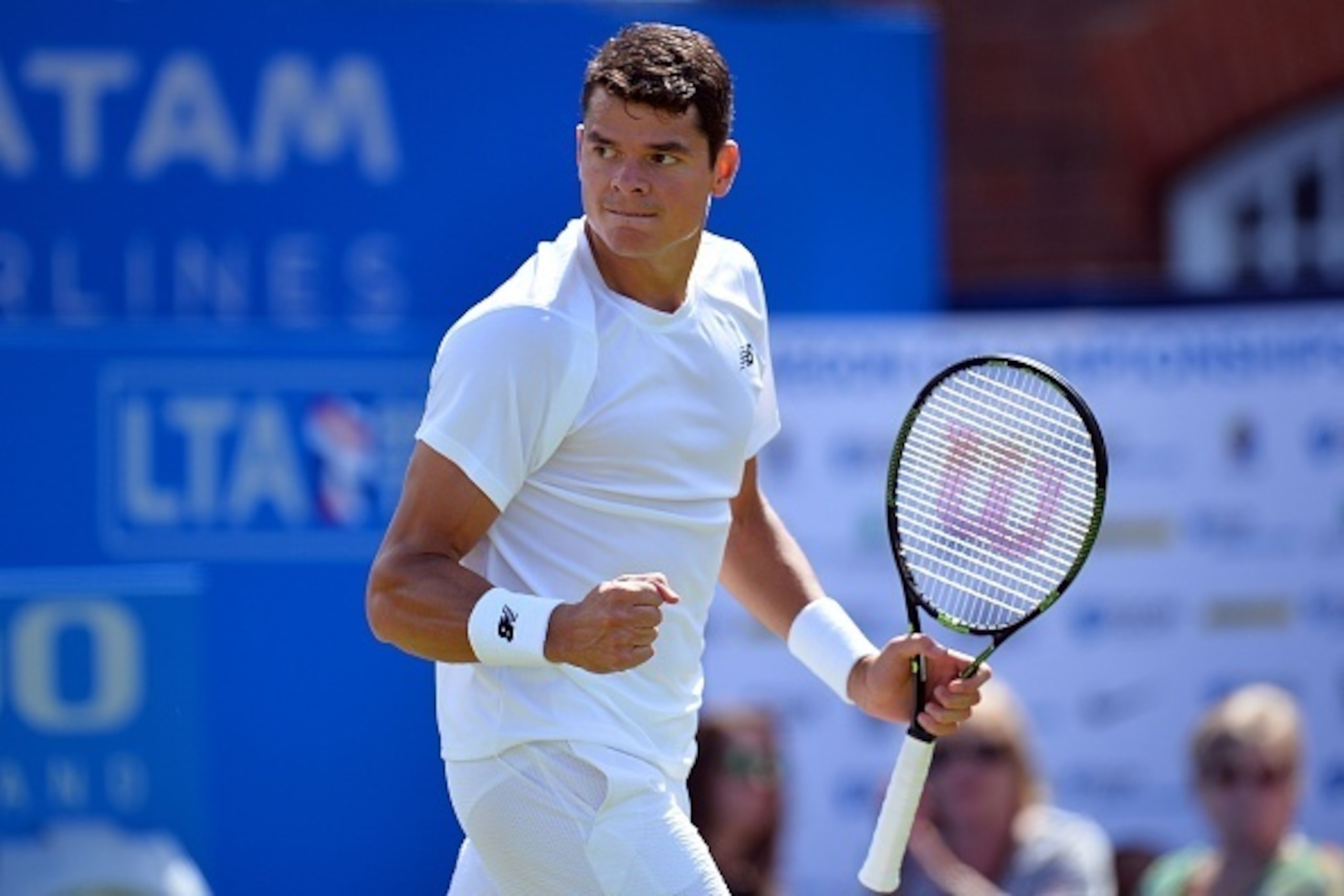 Canada's Milos Raonic celebrates after winning his match against Australia's Nick Kyrgios  during the ATP Aegon Championships tennis tournament at the Queen's Club in west London on June 15, 2016.  / AFP / GLYN KIRK        (Photo credit should read GLYN K