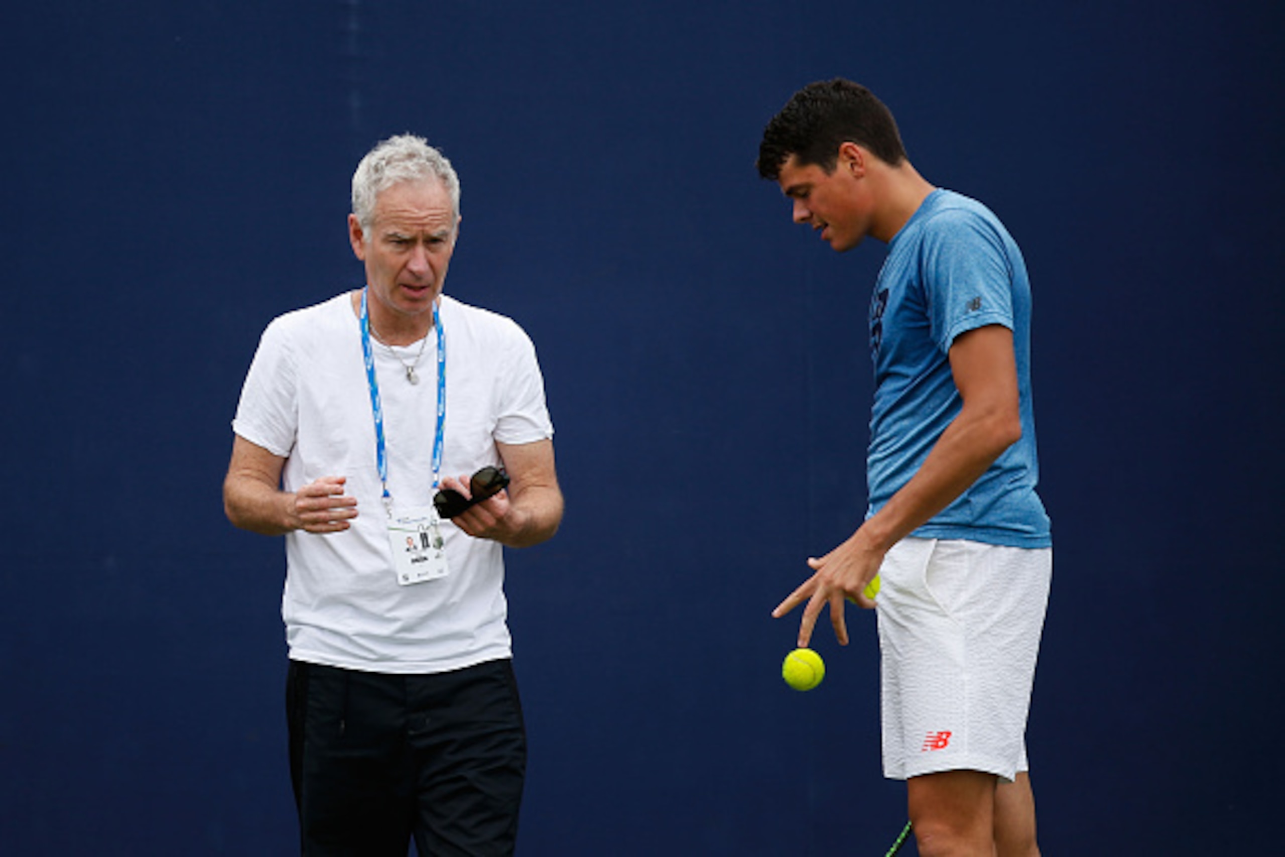LONDON, ENGLAND - JUNE 12:  John McEnroe (L) speaks to Milos Raonic during a practice session at the Aegon Championships at Queens Club on June 12, 2016 in London, England.  (Photo by Joel Ford/Getty Images)