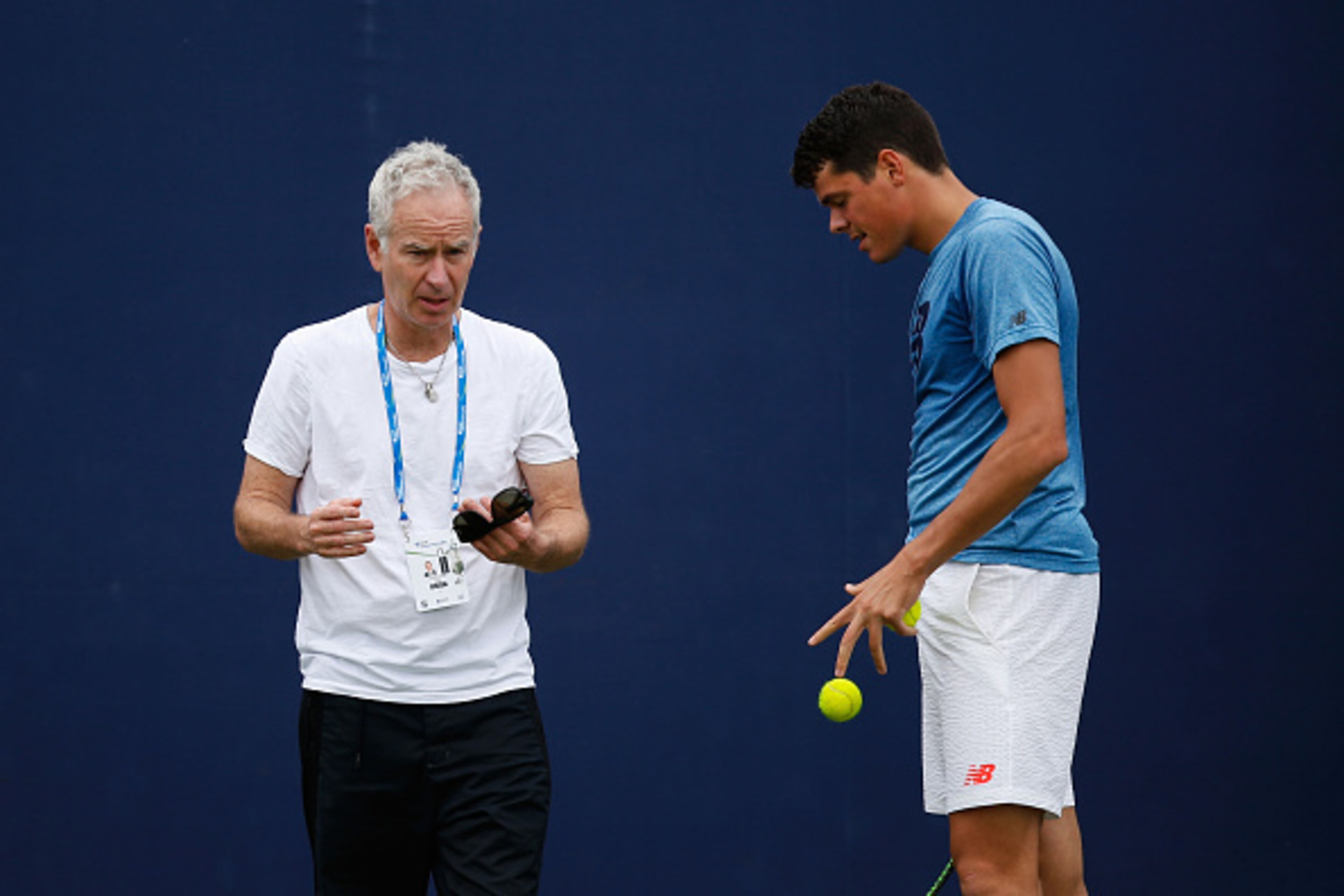 LONDON, ENGLAND - JUNE 12:  John McEnroe (L) speaks to Milos Raonic during a practice session at the Aegon Championships at Queens Club on June 12, 2016 in London, England.  (Photo by Joel Ford/Getty Images)